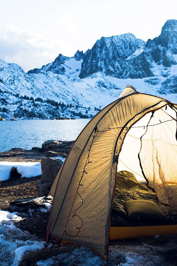 cozy tent, snowy lakeshore, jagged mountains, SD Phone Wallpaper