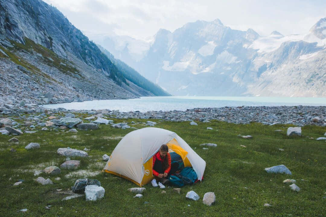yellow and white tent, grassy lakeshore, snow-capped mountains, SD Desktop Wallpaper