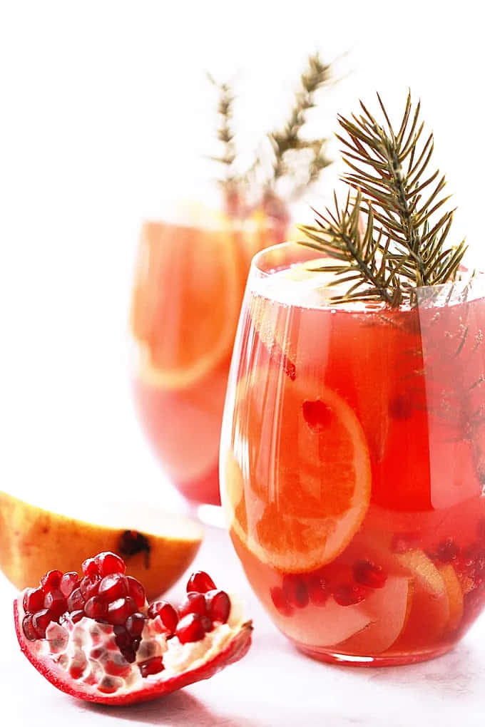 pomegranate and citrus drink, rosemary sprigs, orange slices, SD Phone Wallpaper