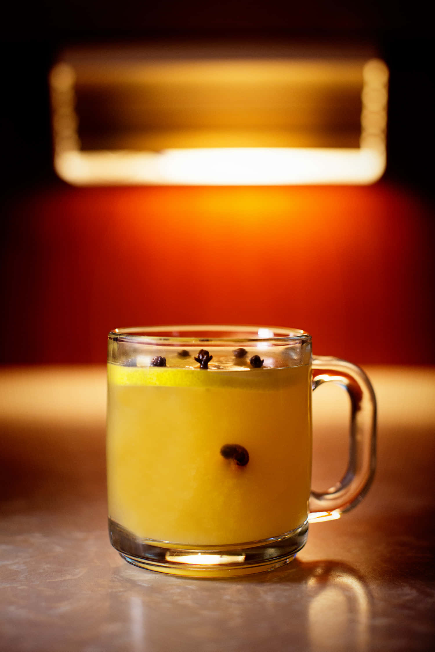 amber drink, floating spices, soft overhead light, Full HD Phone Wallpaper