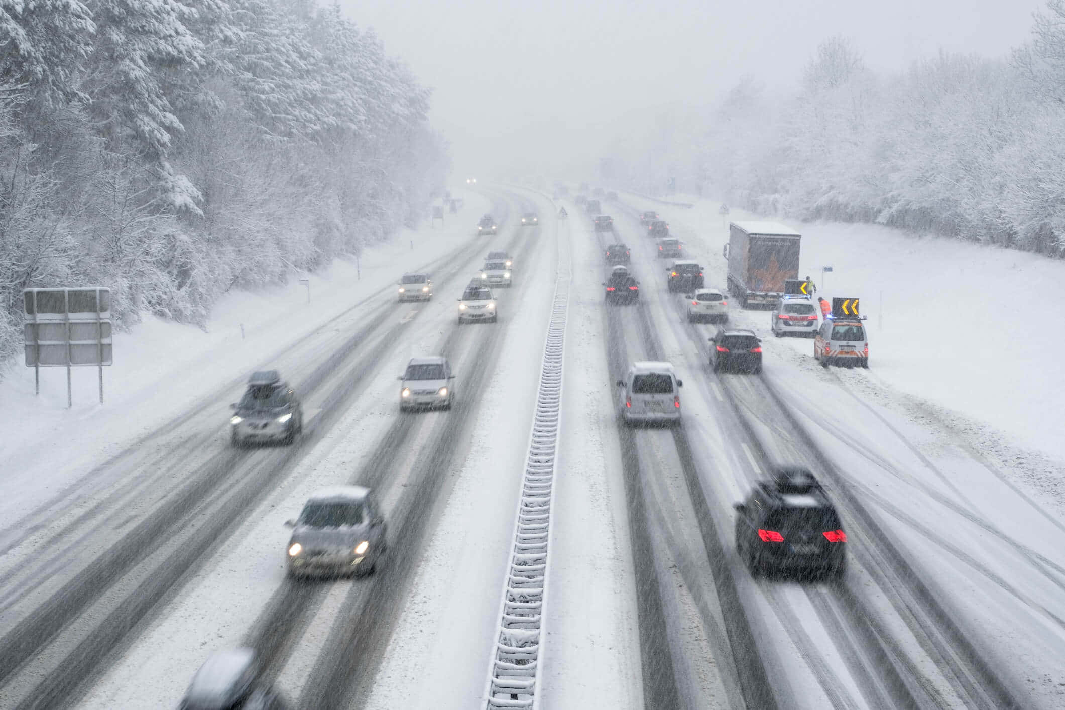 snow-covered highway, heavy blizzard conditions, snow-laden trees, Full HD Desktop Wallpaper
