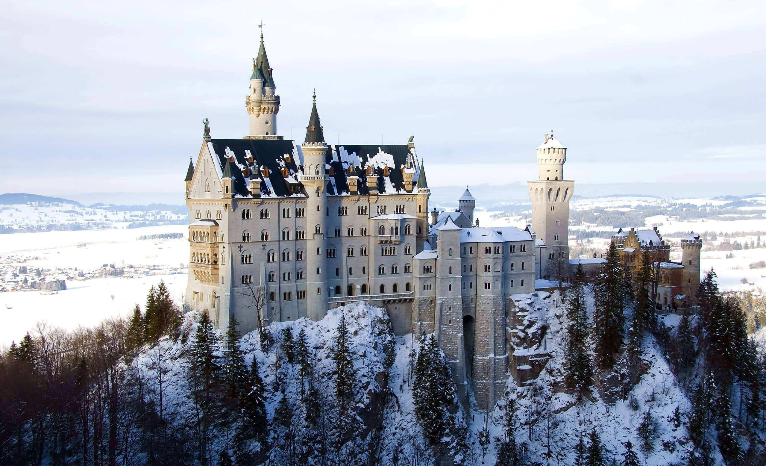 snow-covered castle, forested hill, frozen valley, Full HD Desktop Wallpaper