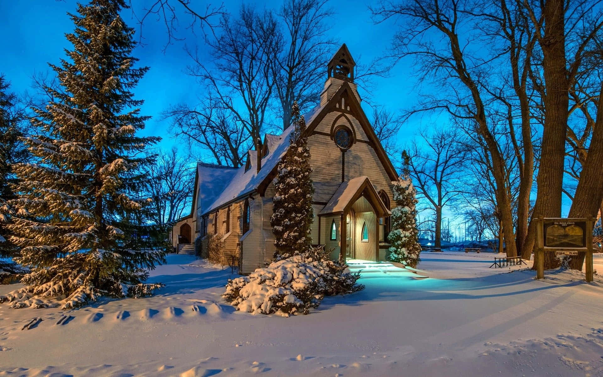 Winter Holiday Desktop, snow-covered church, glowing windows, Full HD Desktop Wallpaper