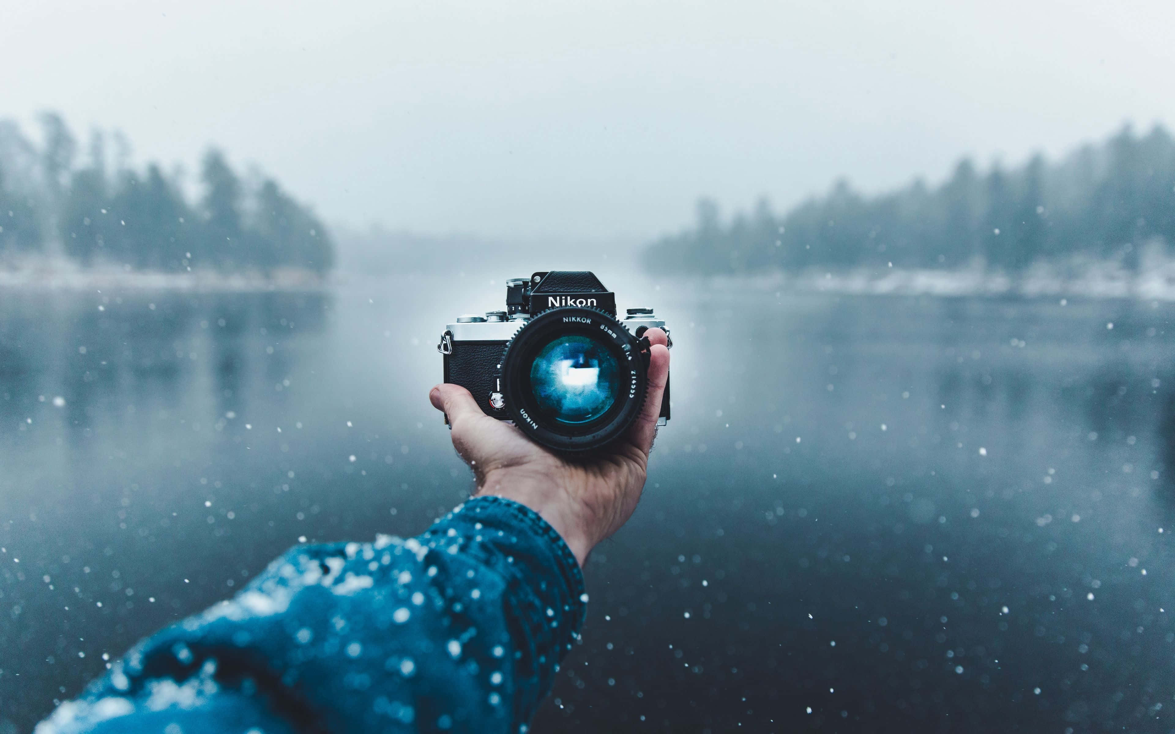 vintage Nikon camera, snowy lake, snowflakes falling, 4K Desktop Wallpaper
