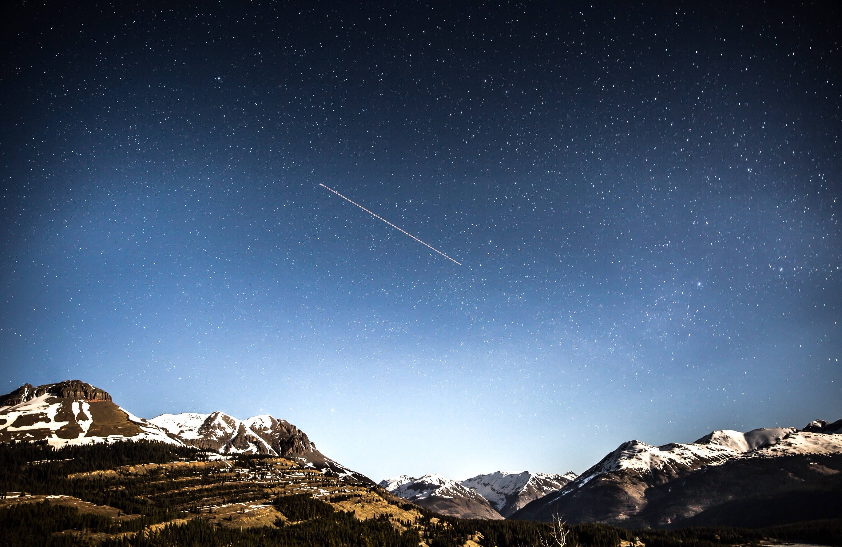 snowcapped mountains, starry night sky, bright meteor, 2K Desktop Wallpaper