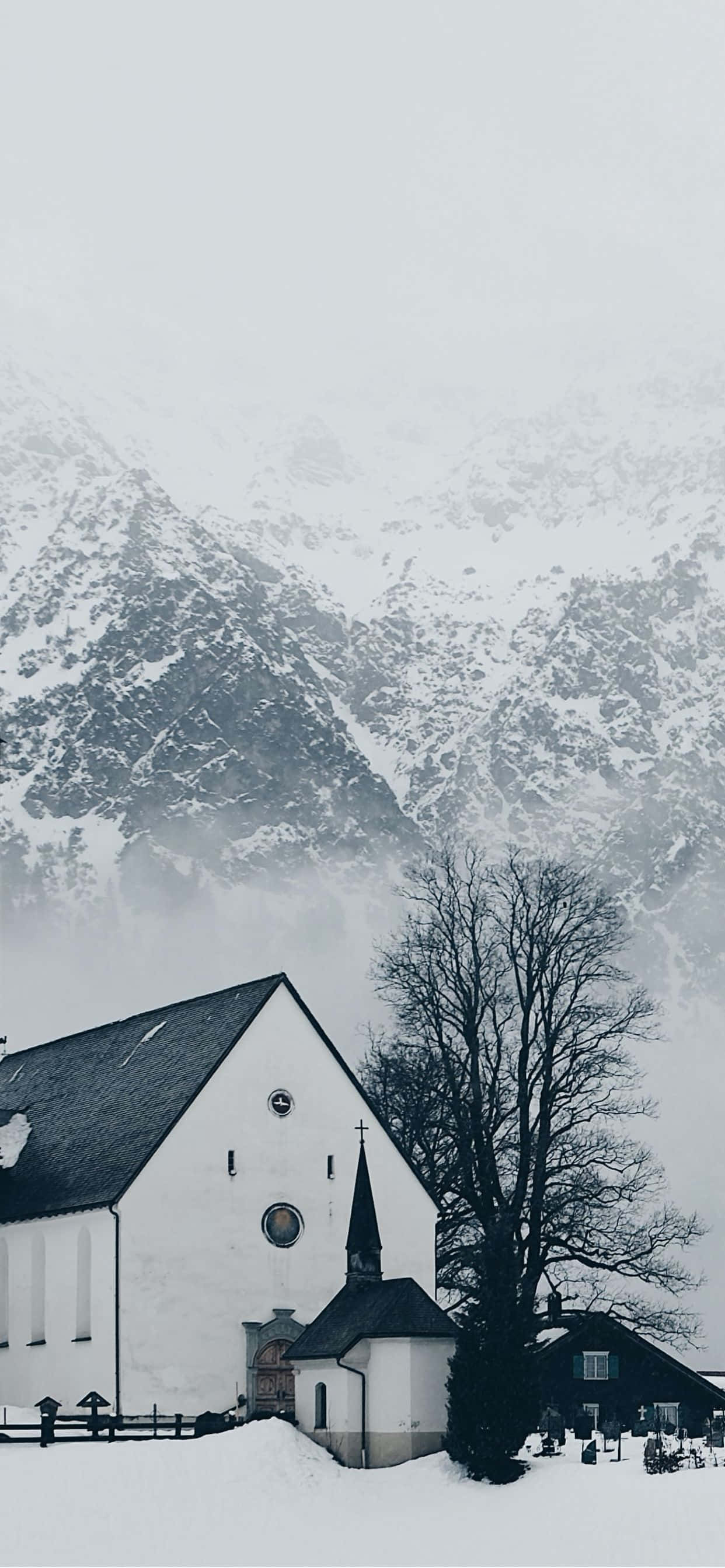 Winter Wonderland, snow-covered church, towering misty mountains, 2K Phone Wallpaper