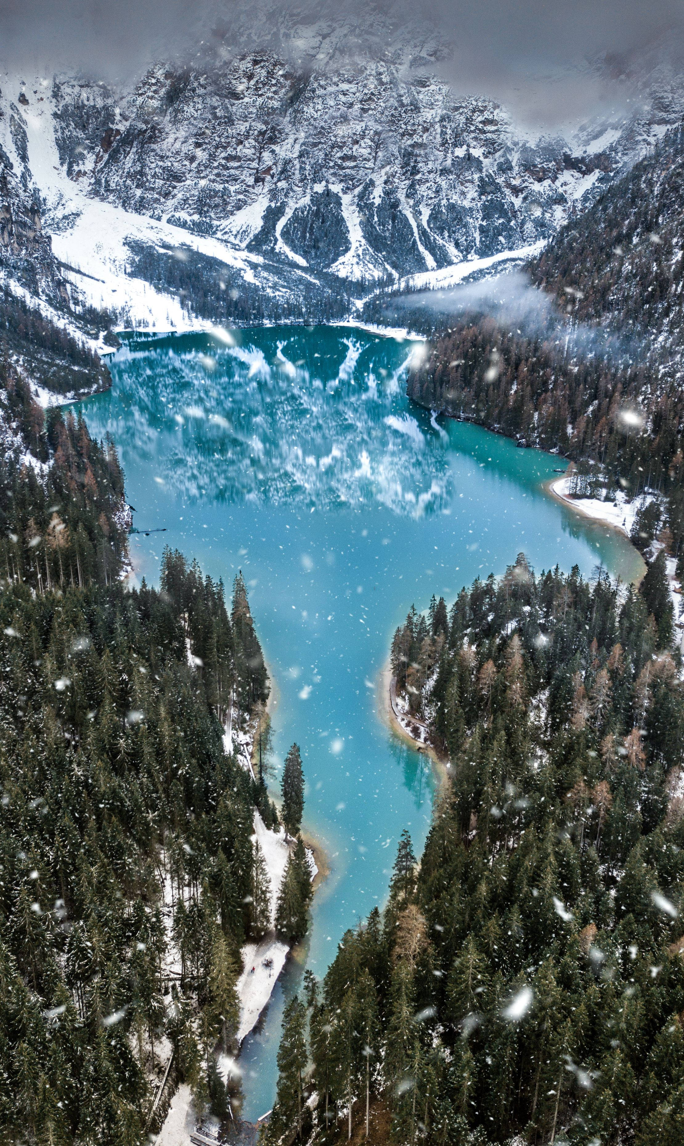 turquoise alpine lake, snow-capped mountains, evergreen forests, 2K Phone Wallpaper