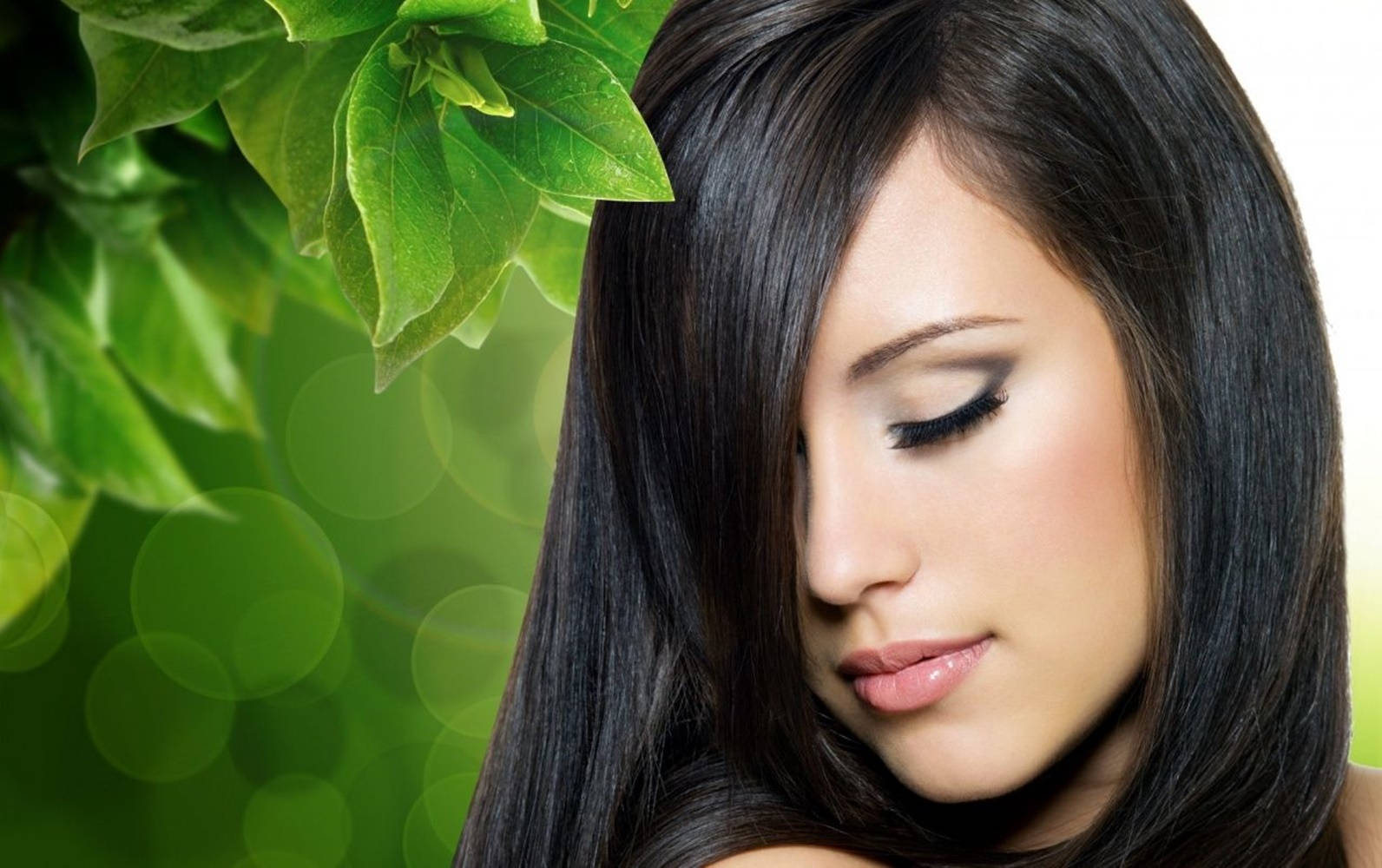 woman face, long dark hair, vibrant green leaves, HD Desktop Wallpaper