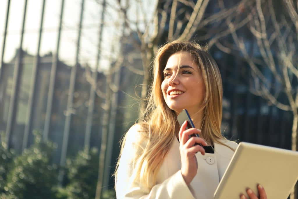 smiling woman, white coat, phone, SD Desktop Wallpaper