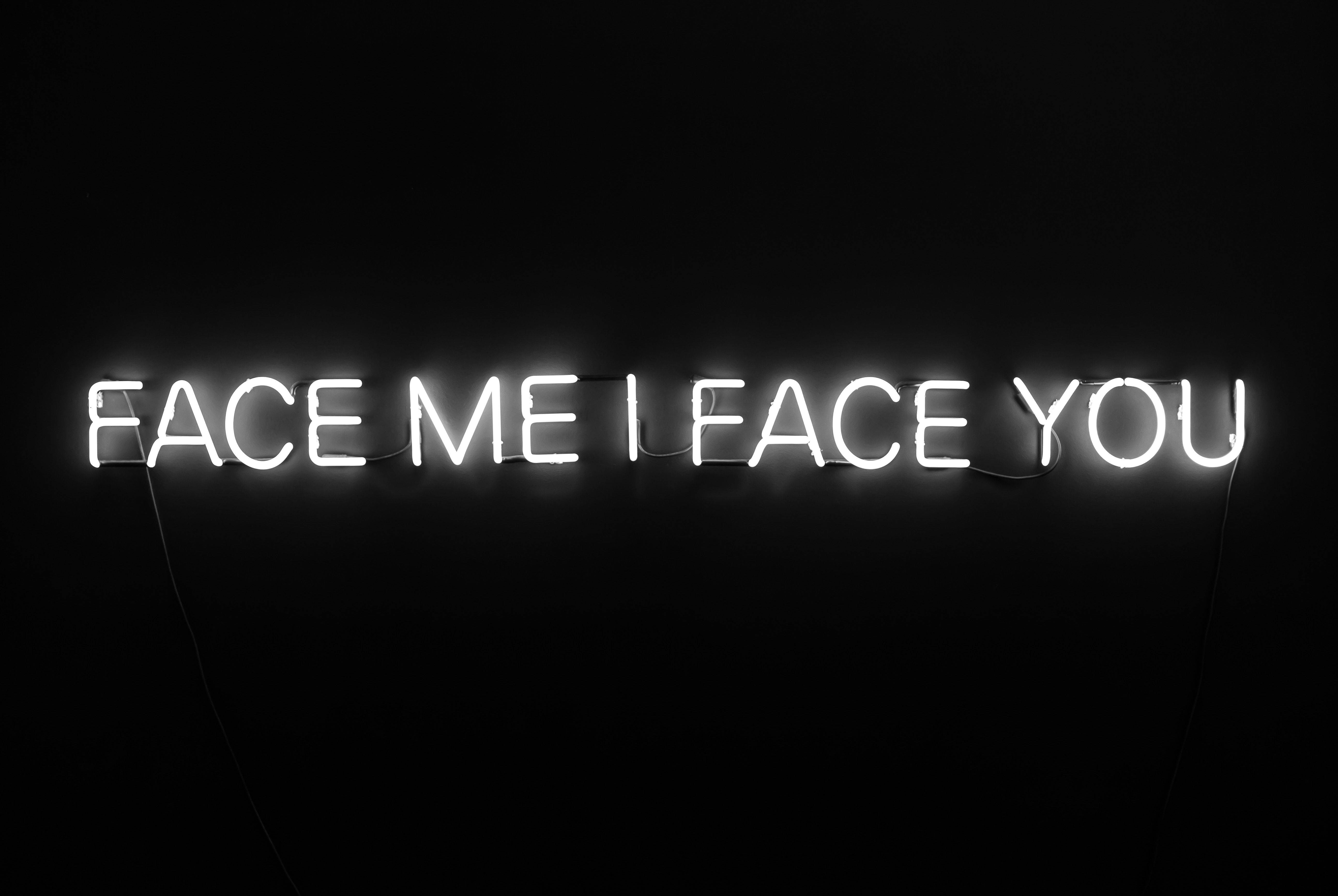 white neon sign, face me i face you, pitch black wall, 5K Desktop Wallpaper