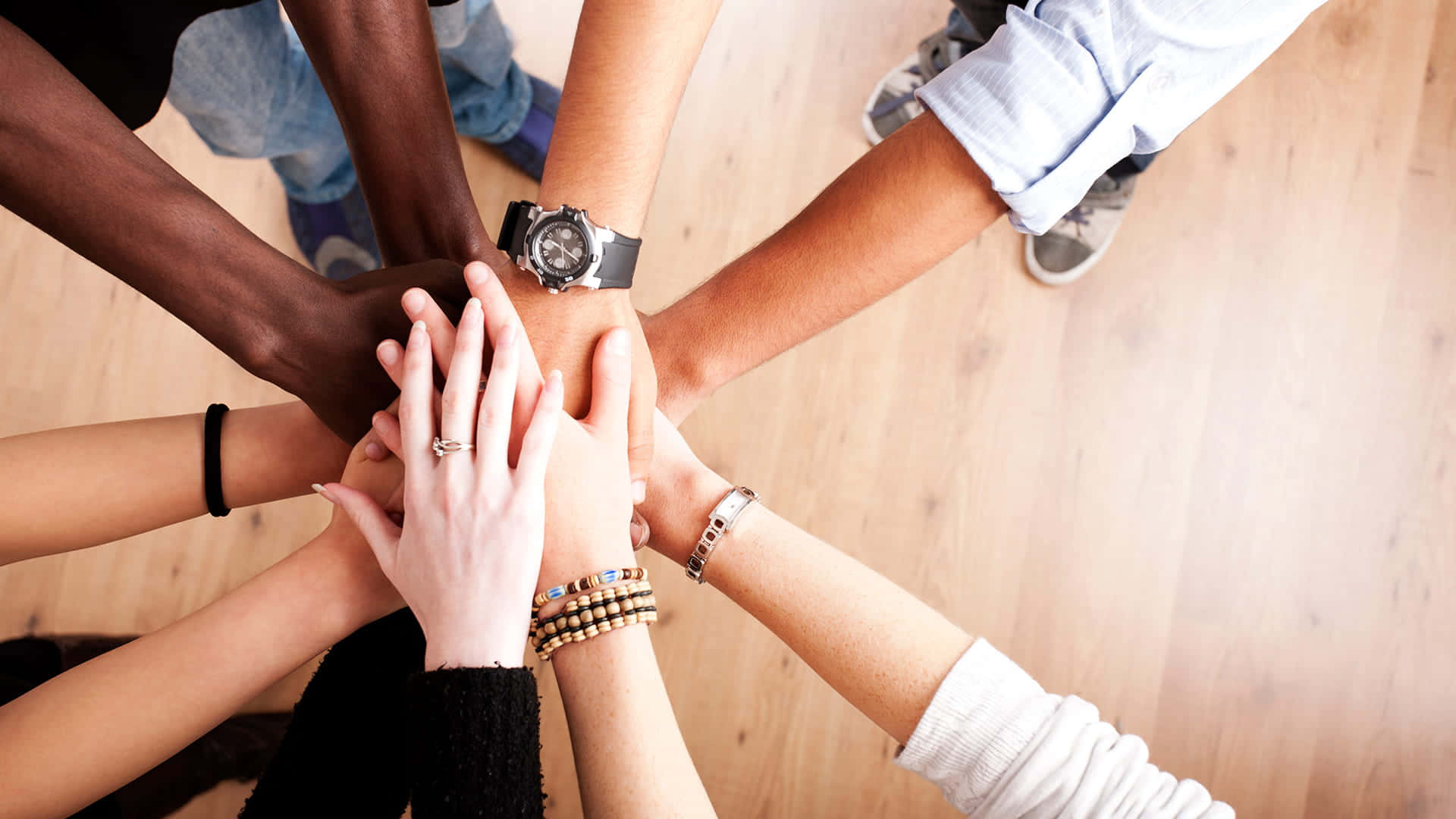 Inclusive Work Environment HD, top-down view, diverse hands, Full HD Desktop Wallpaper