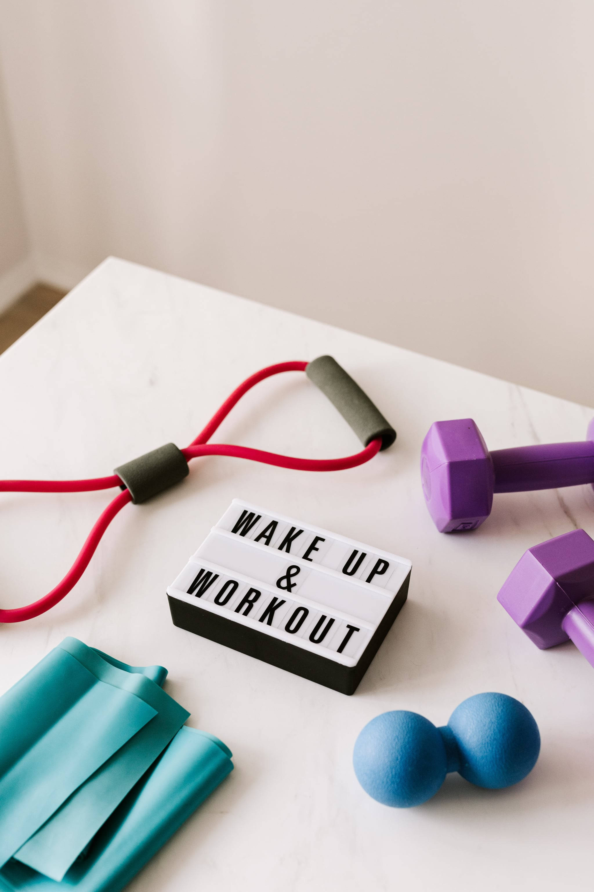 white tabletop, purple dumbbells, red resistance band, 2K Phone Wallpaper