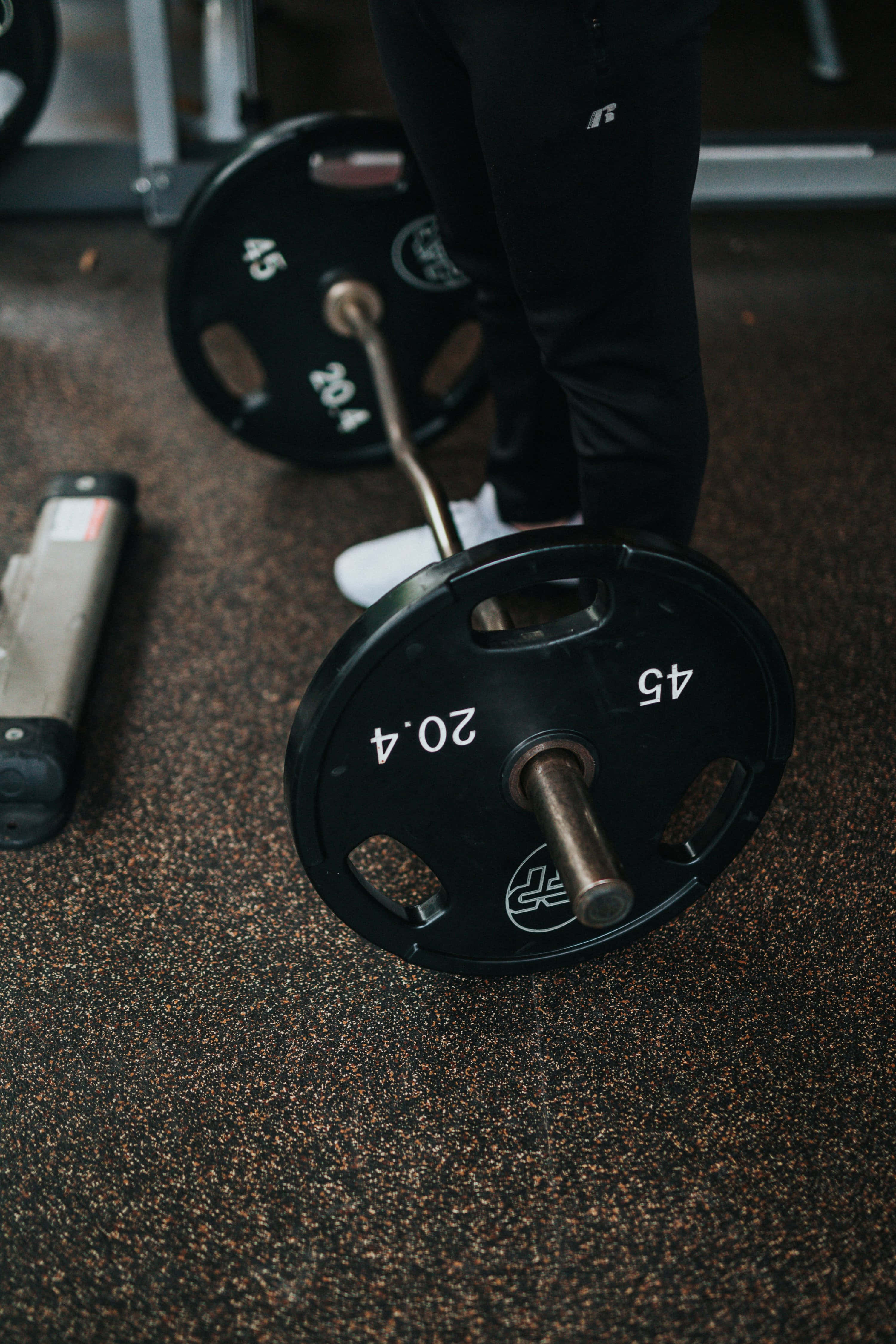 barbell, 45lb weight plates, speckled gym floor, 4K Phone Wallpaper