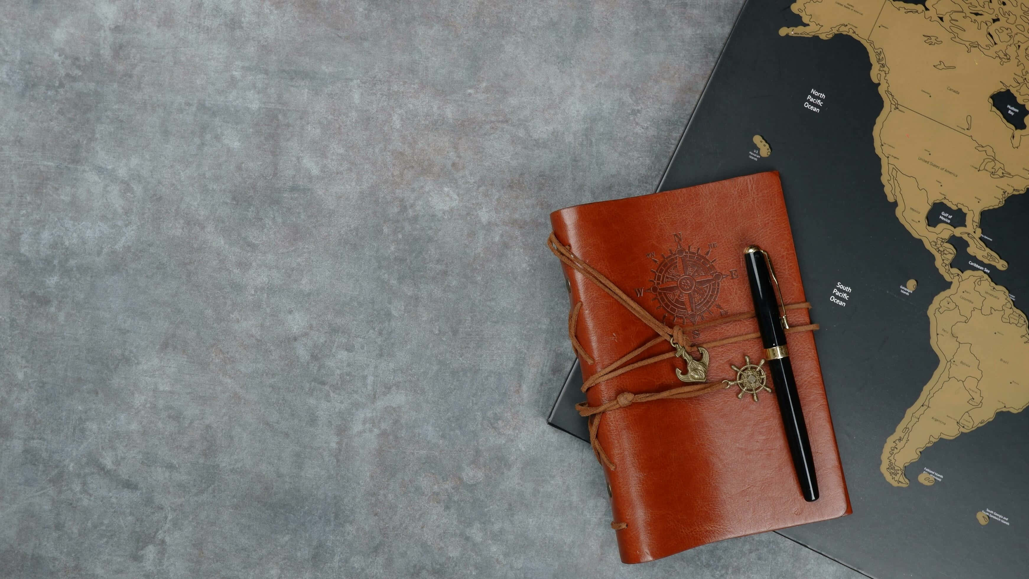 brown leather-bound journal, nautical charms, world map, 2K Desktop Wallpaper