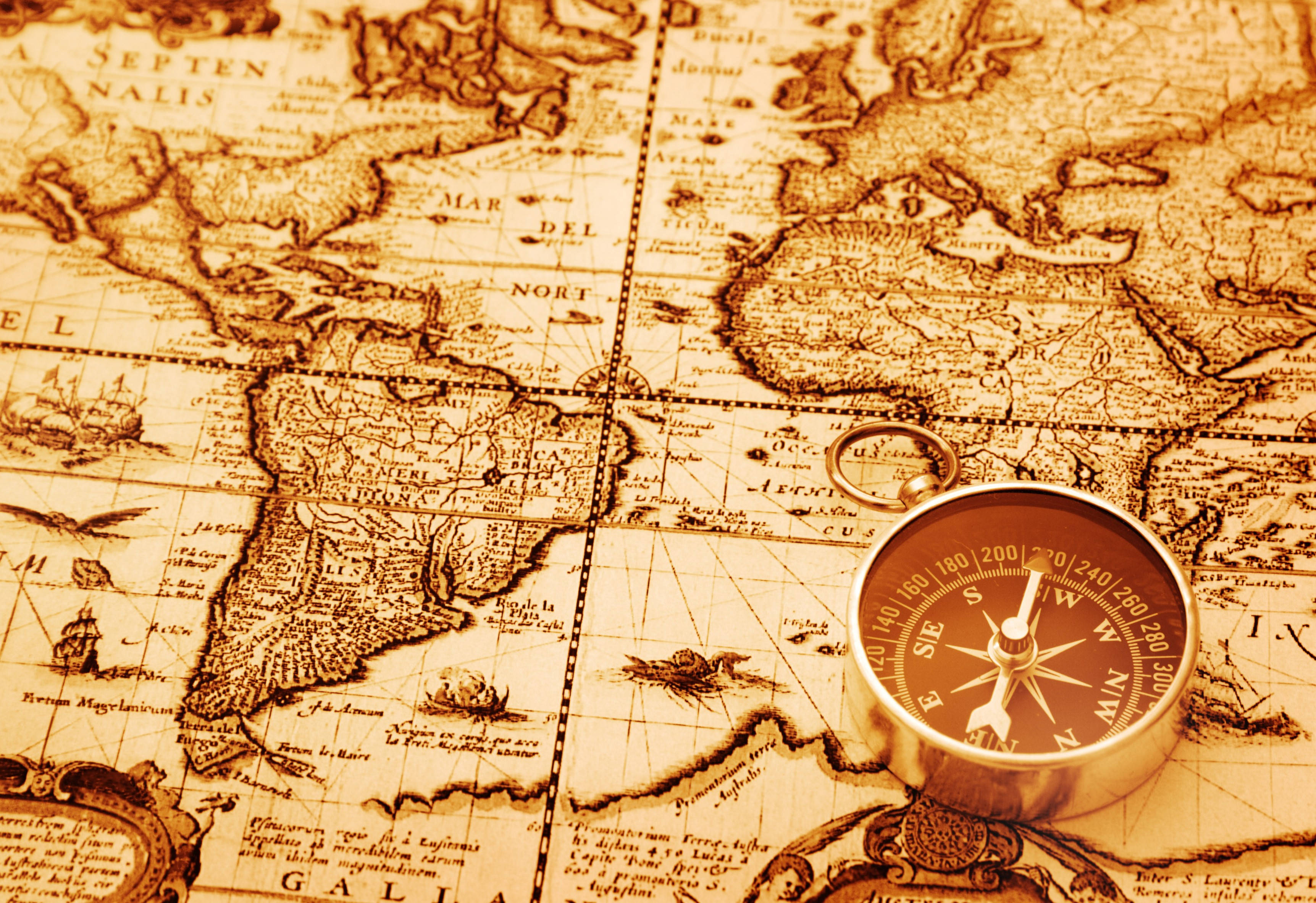 antique brass compass, vintage sepia-toned world map, continents, 2K Desktop Wallpaper