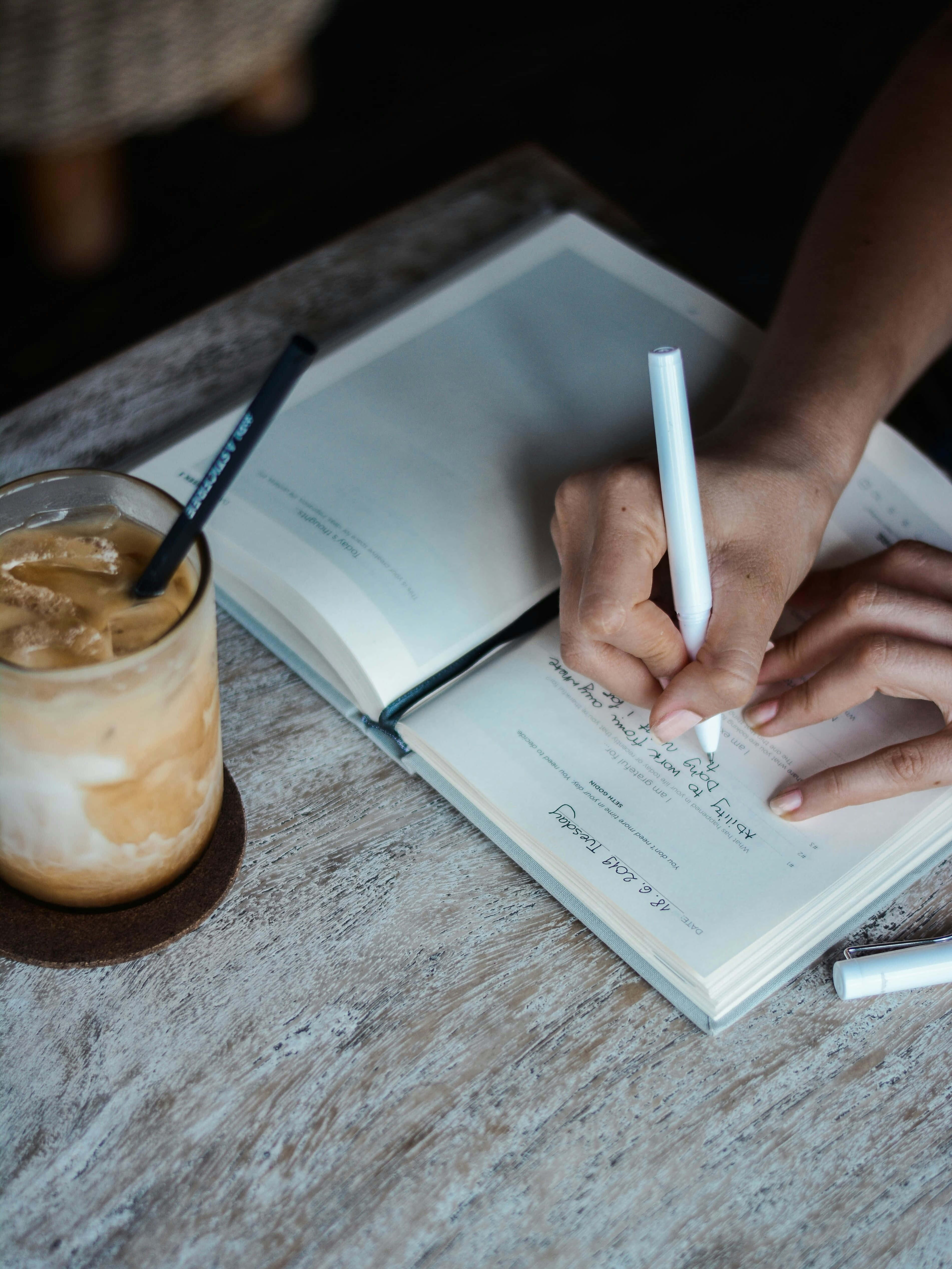 creative writing session, iced coffee drink, rustic wooden table, 4K Phone Wallpaper