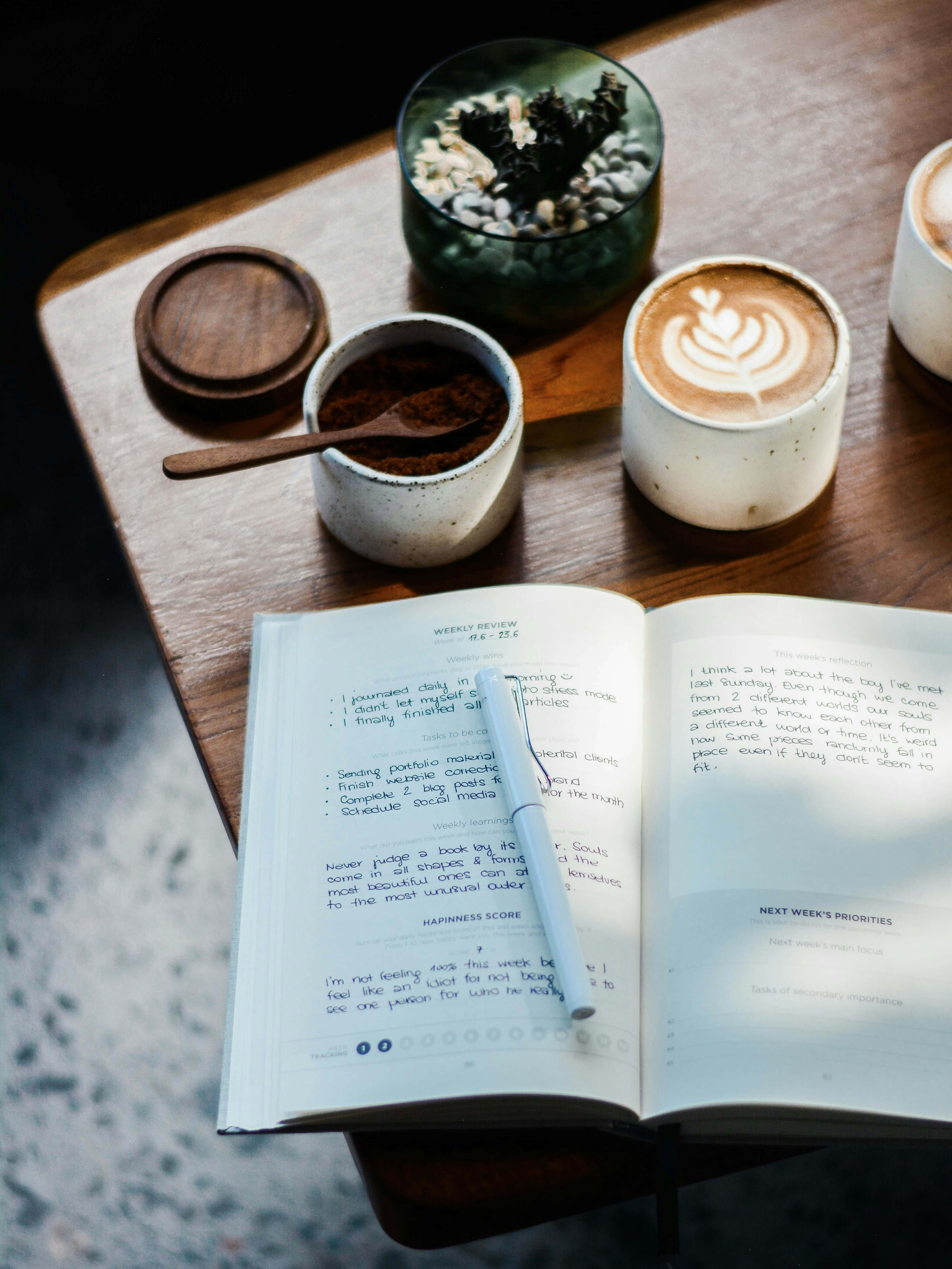 Cafe Journaling Moment, wooden table, open journal, 4K Phone Wallpaper