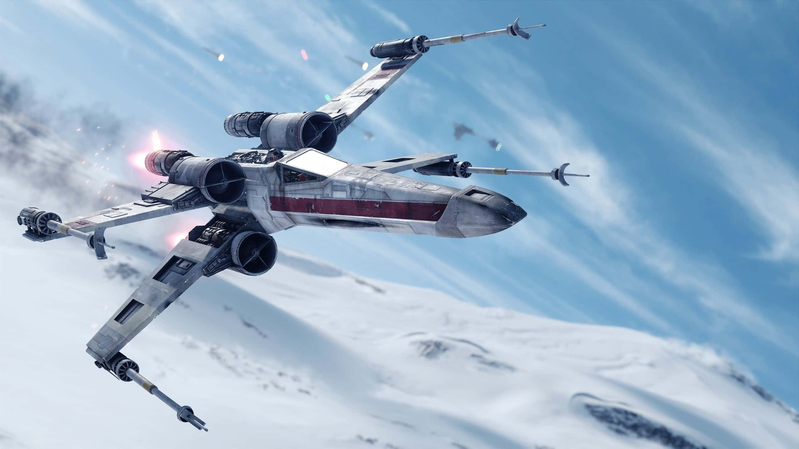 X-wing Fighter, snow-covered mountains, bright blue sky, 2K Desktop Wallpaper