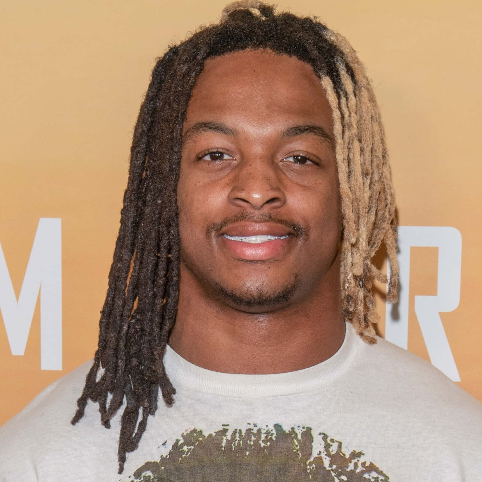 Xavier Mckinney, dark and blonde dreadlocks, warm orange backdrop, HD Desktop Wallpaper
