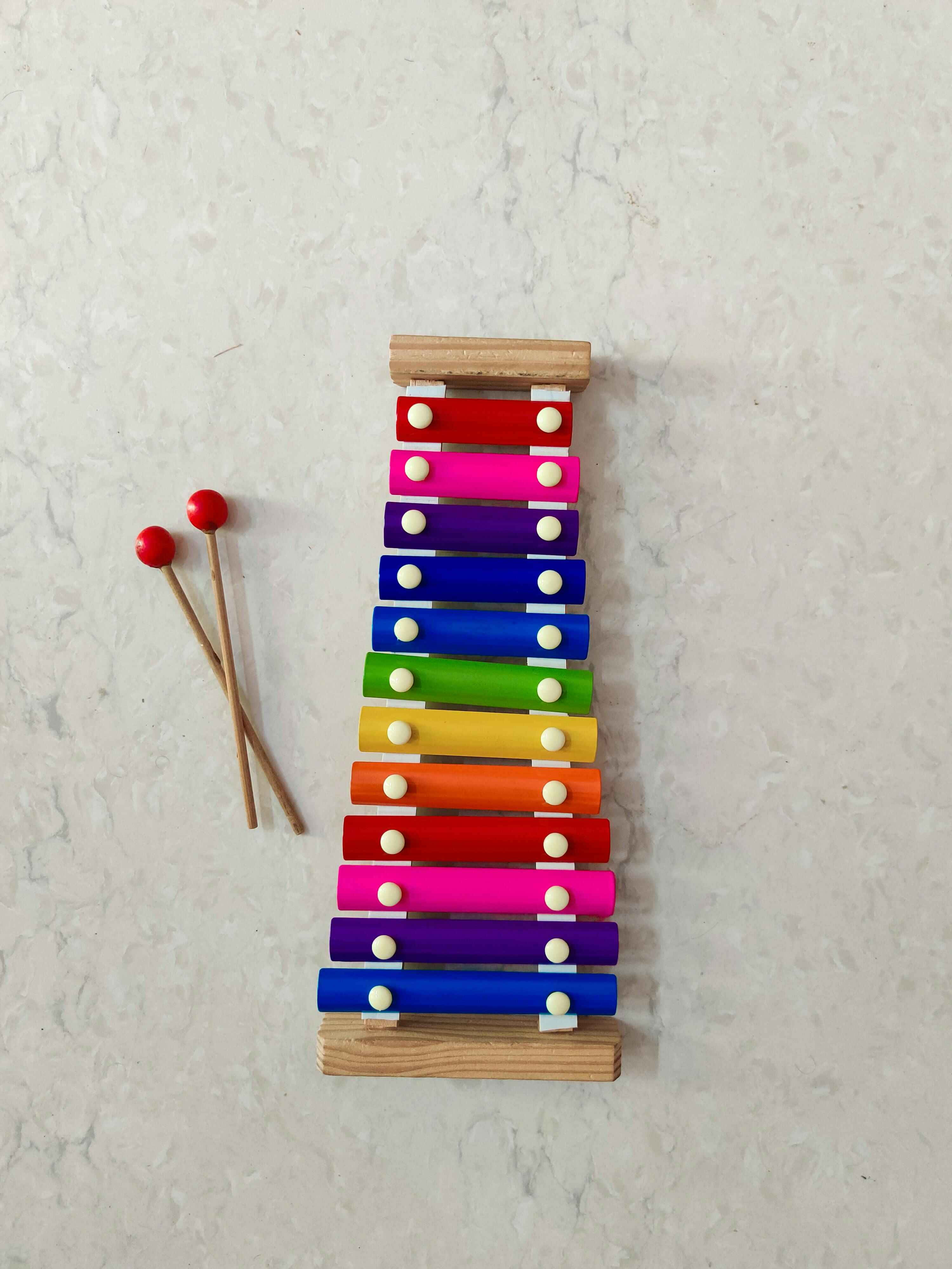 colorful rainbow xylophone, red-tipped mallets, light speckled surface, 4K Phone Wallpaper