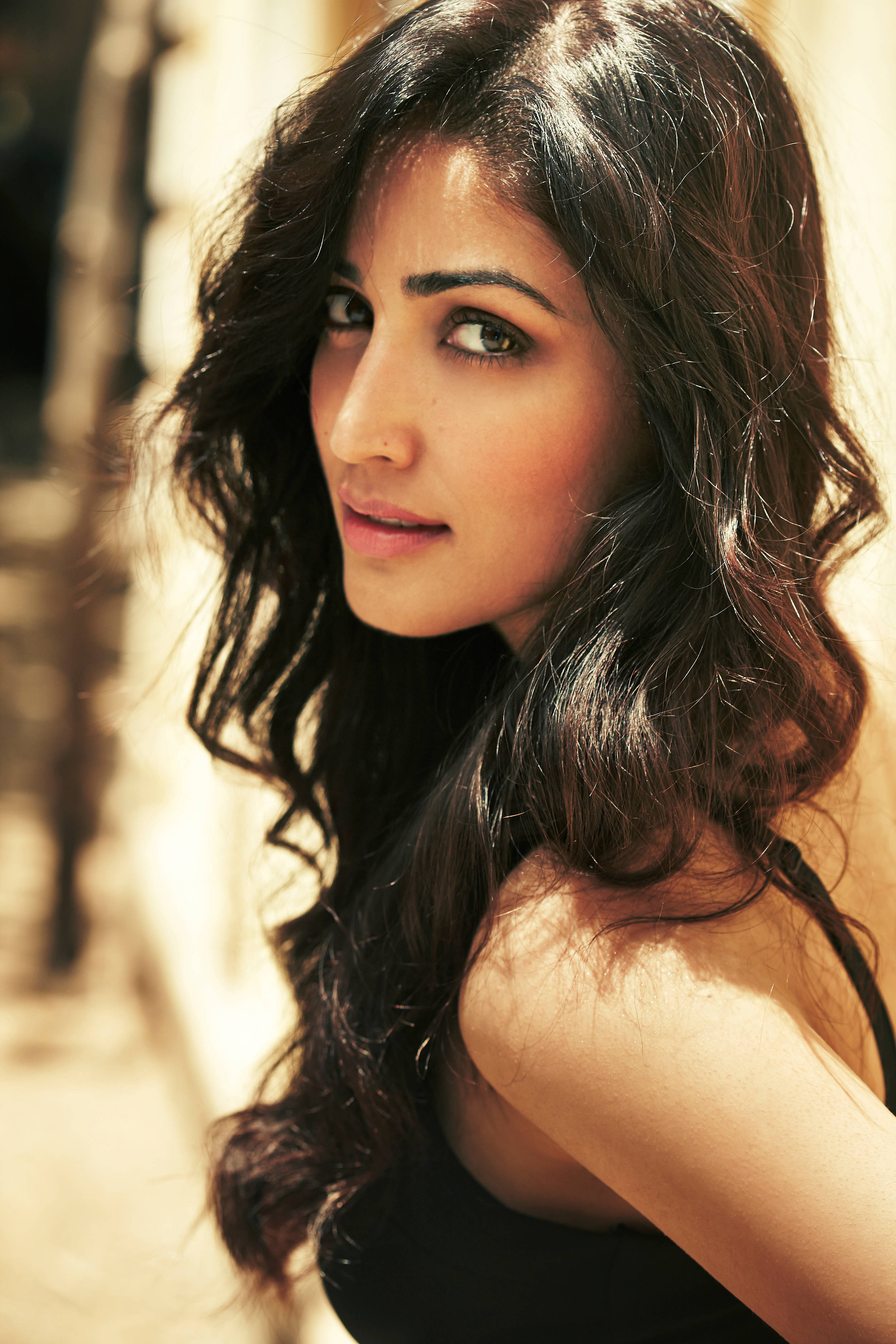 Yami Gautam, long dark wavy hair, warm golden sunlight, 2K Phone Wallpaper