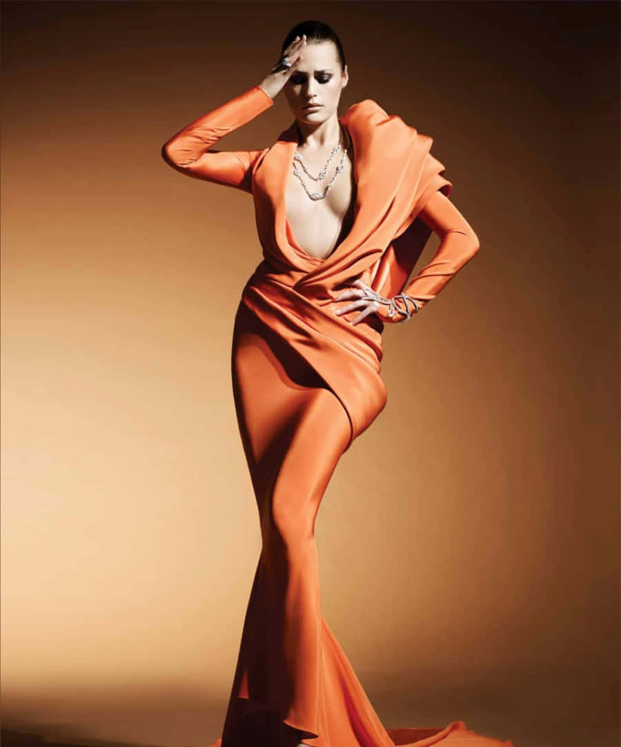 Yasmin Le Bon, orange gown, warm gradient backdrop, SD Phone Wallpaper
