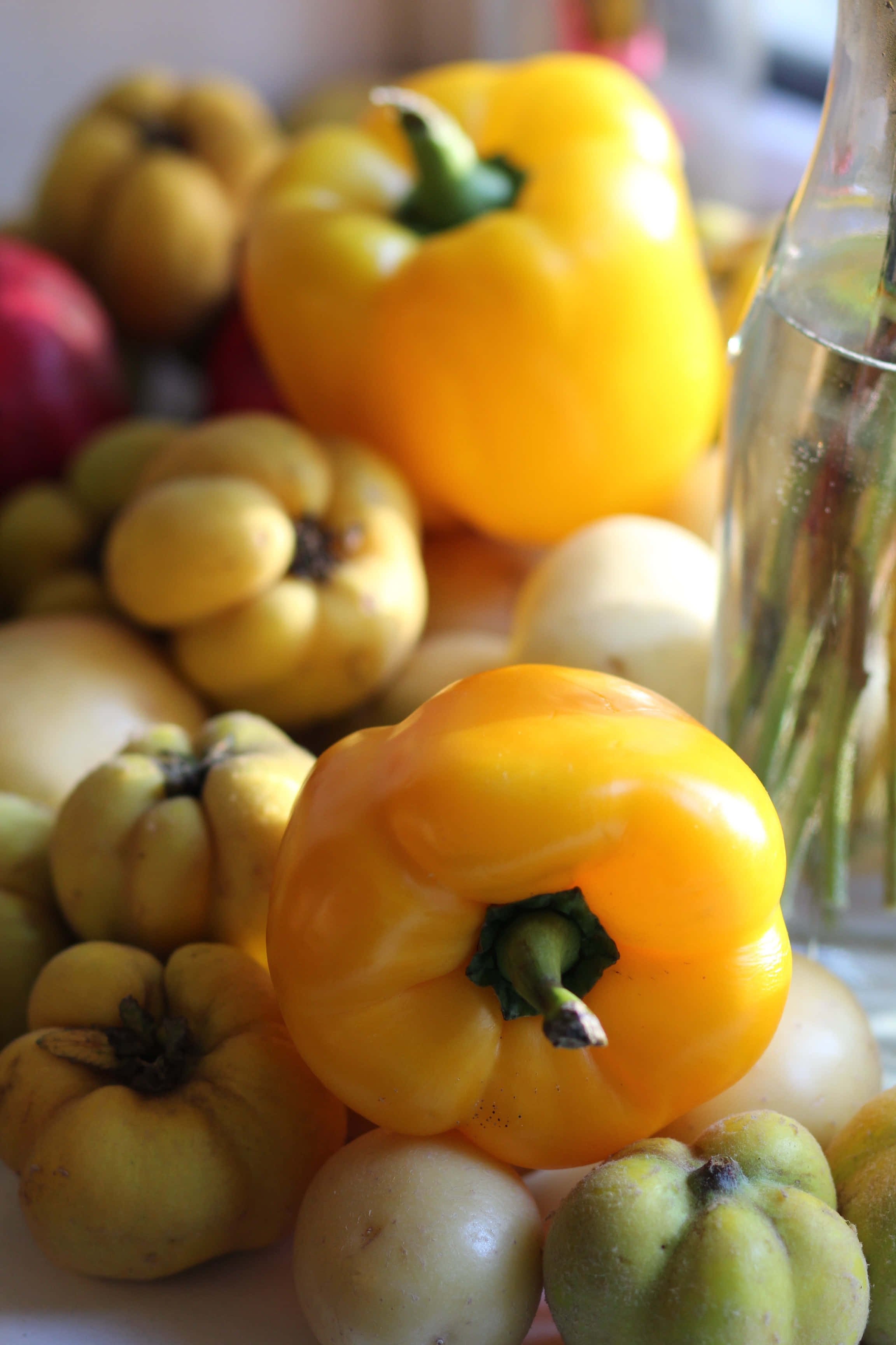 yellow bell pepper, quince fruits, glass bottle of water, 2K Phone Wallpaper