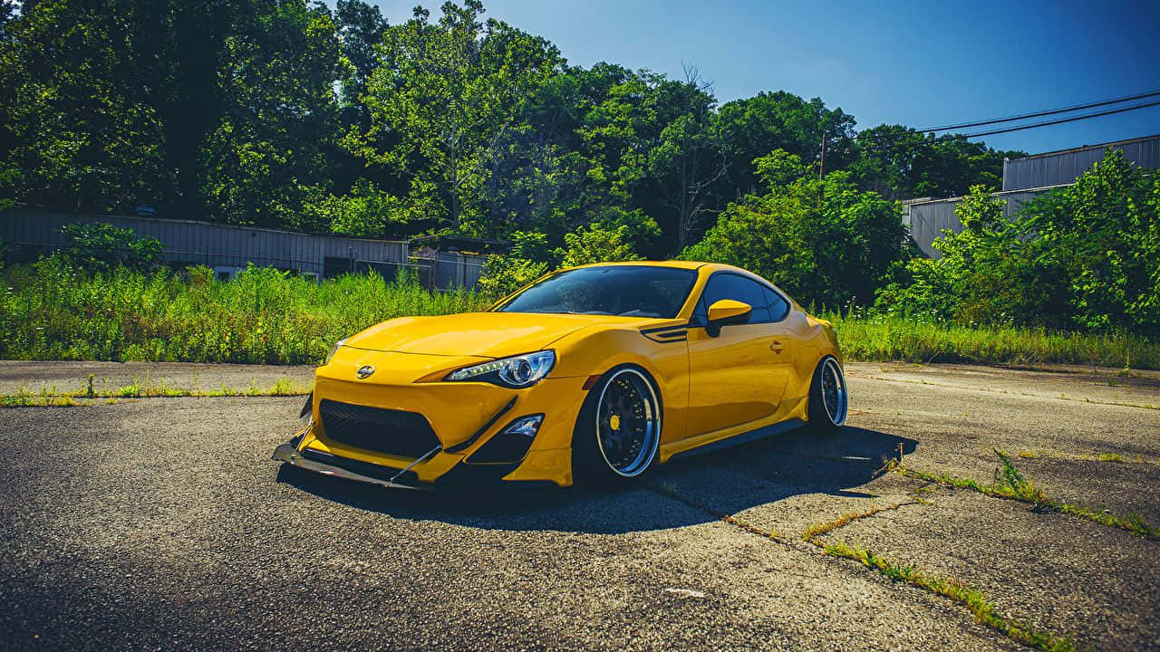 vibrant yellow modified sports car, cracked asphalt, bright sunlight, HD Desktop Wallpaper