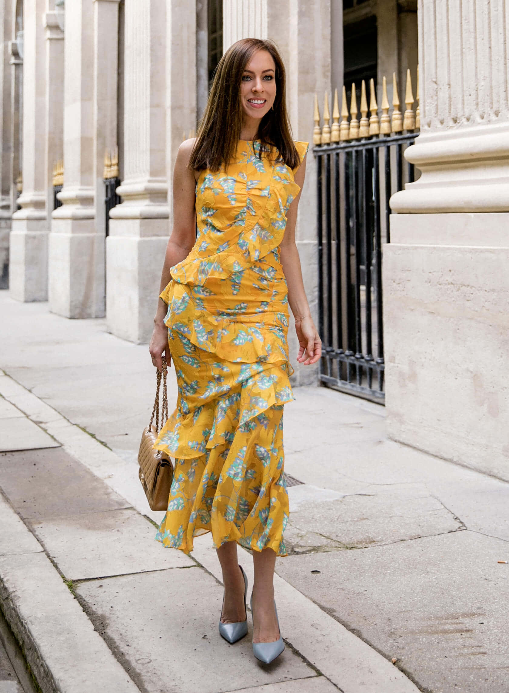 vibrant yellow floral ruffled dress, stone-paved sidewalk, classical columns, Full HD Phone Wallpaper
