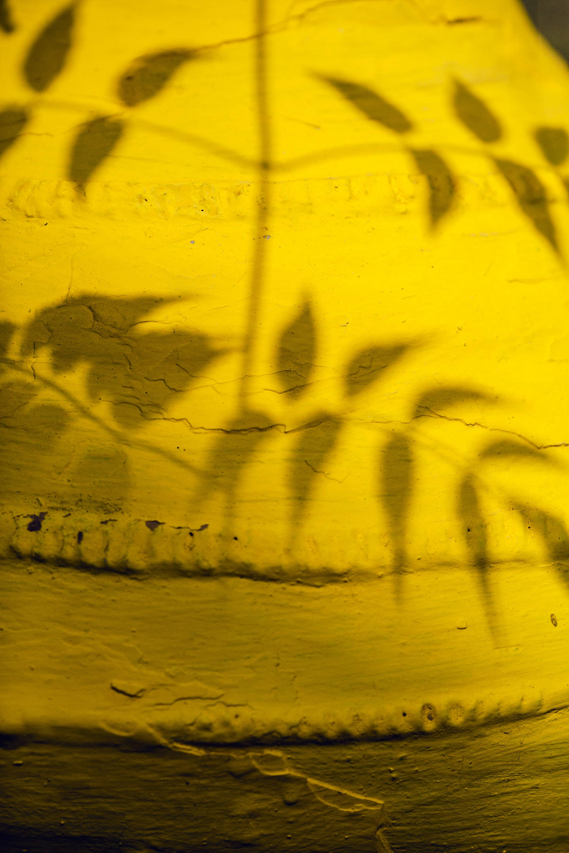 Yellow HD iPhone, vibrant yellow, textured wall, 2K Phone Wallpaper