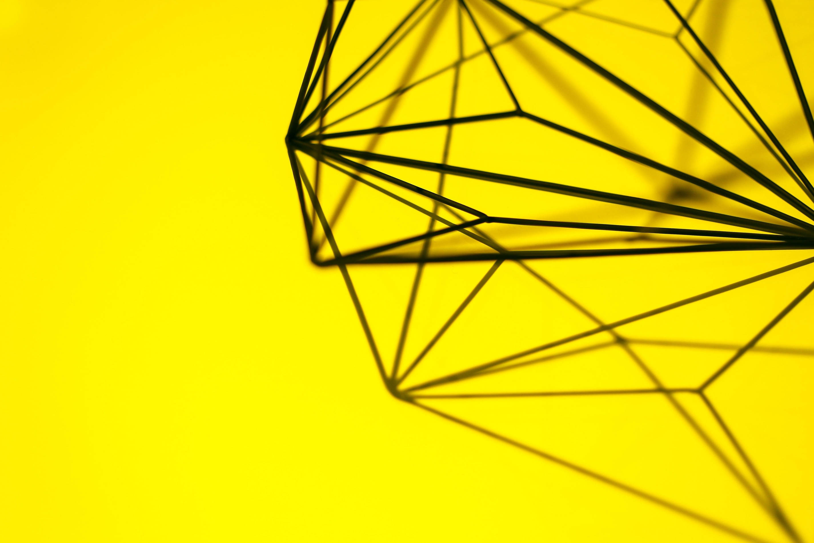 Yellow Aesthetic Diamond Computer, black geometric wireframe sculpture, vibrant yellow background, 2K Desktop Wallpaper