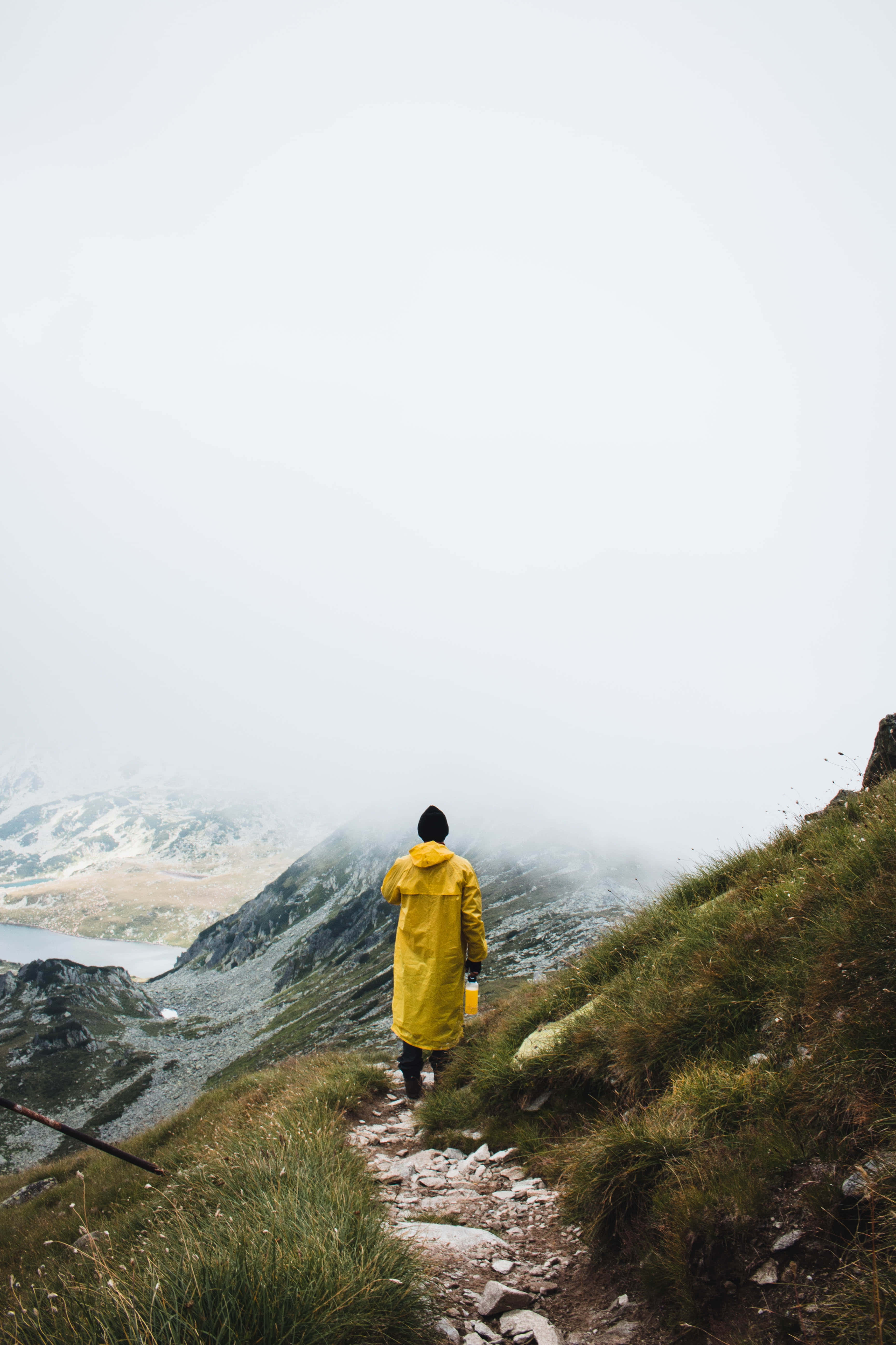 yellow raincoat, misty mountain trail, fog-covered valley, 5K Phone Wallpaper