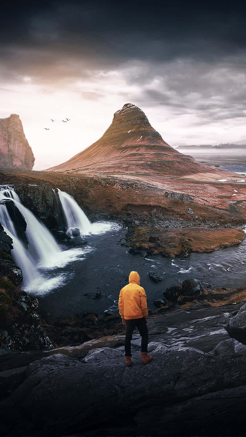 yellow raincoat, rocky cliff, dramatic waterfall, HD Phone Wallpaper