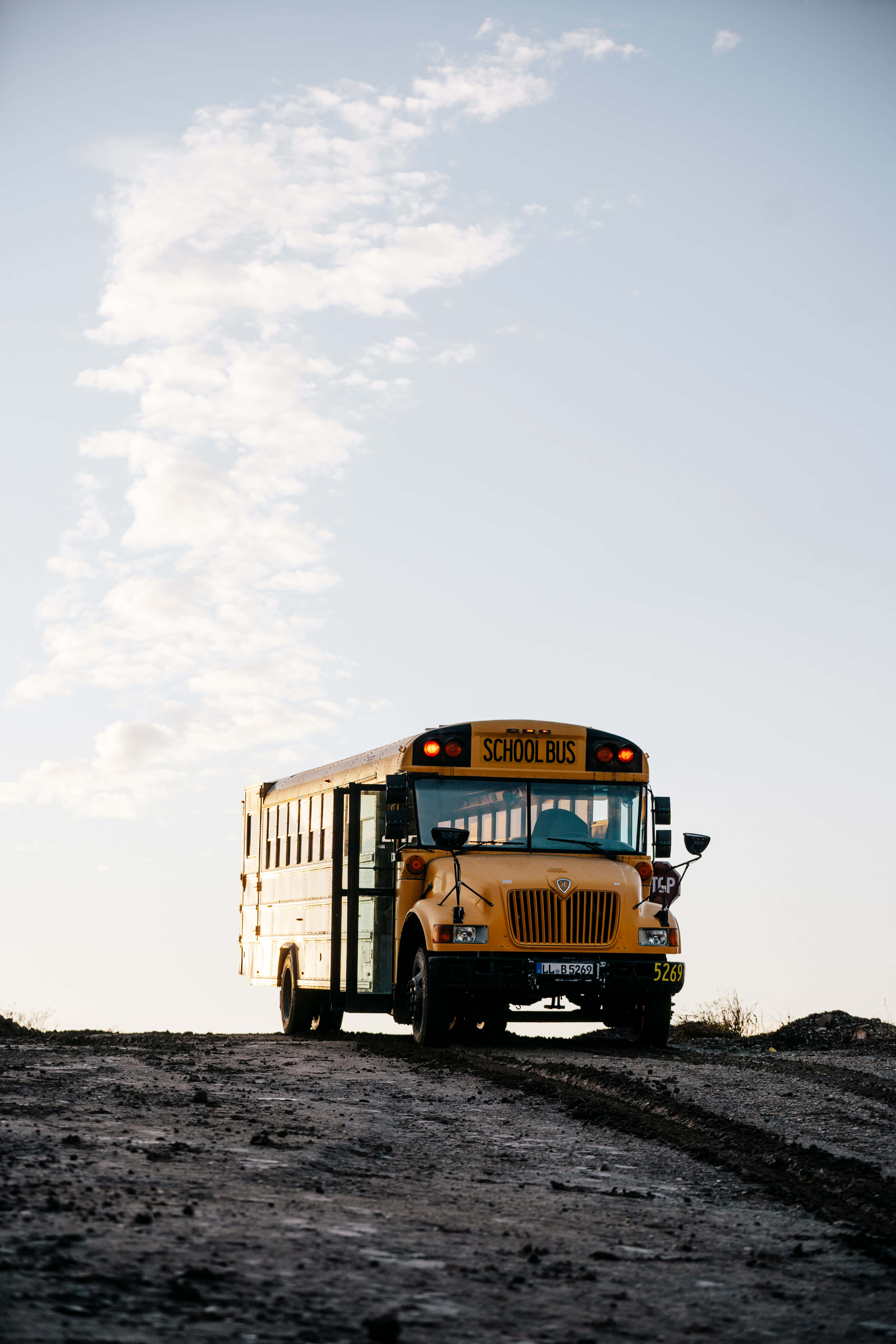yellow school bus, dirt road, vast sky, 5K Phone Wallpaper