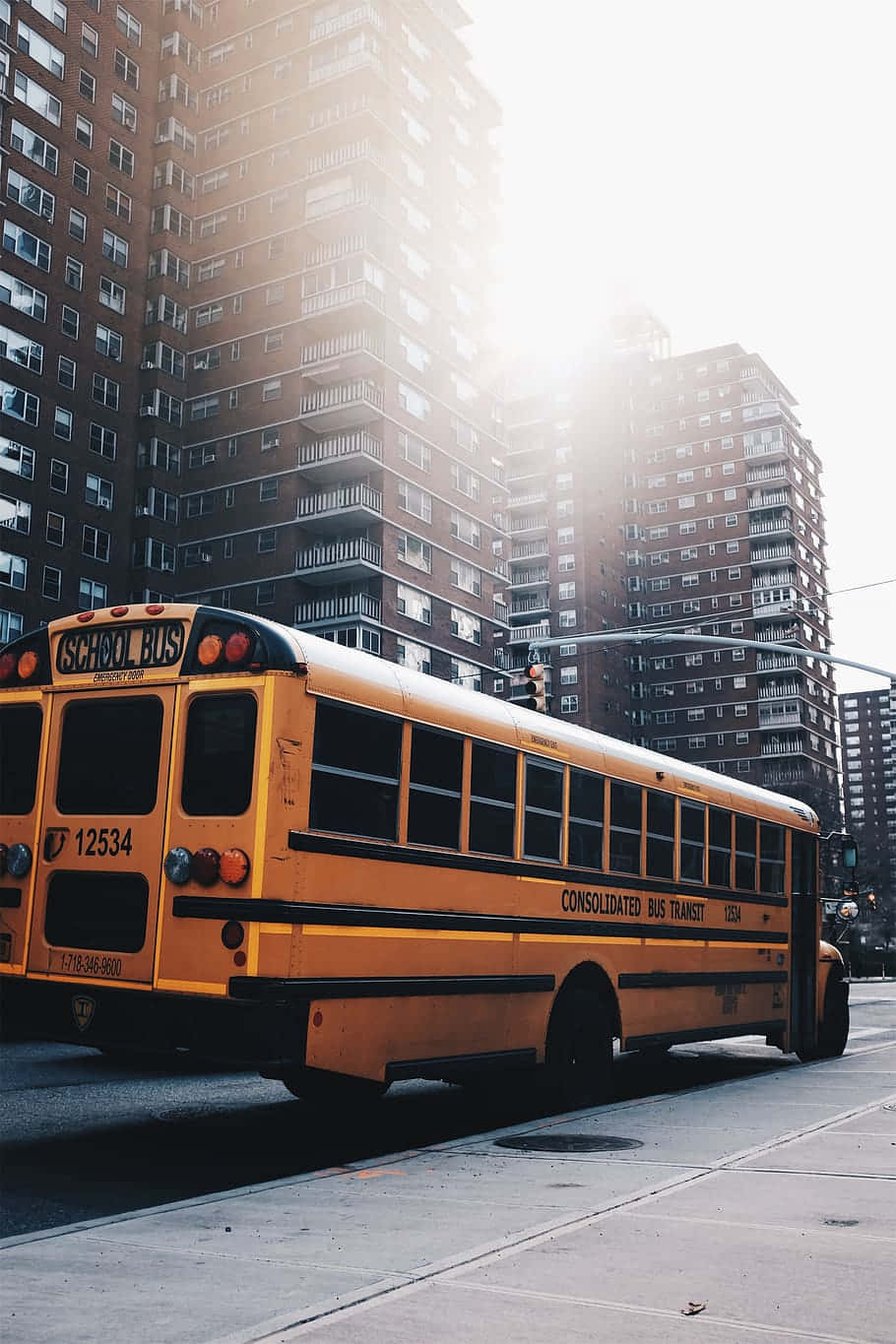 yellow school bus, city street, tall brick apartment buildings, HD Phone Wallpaper