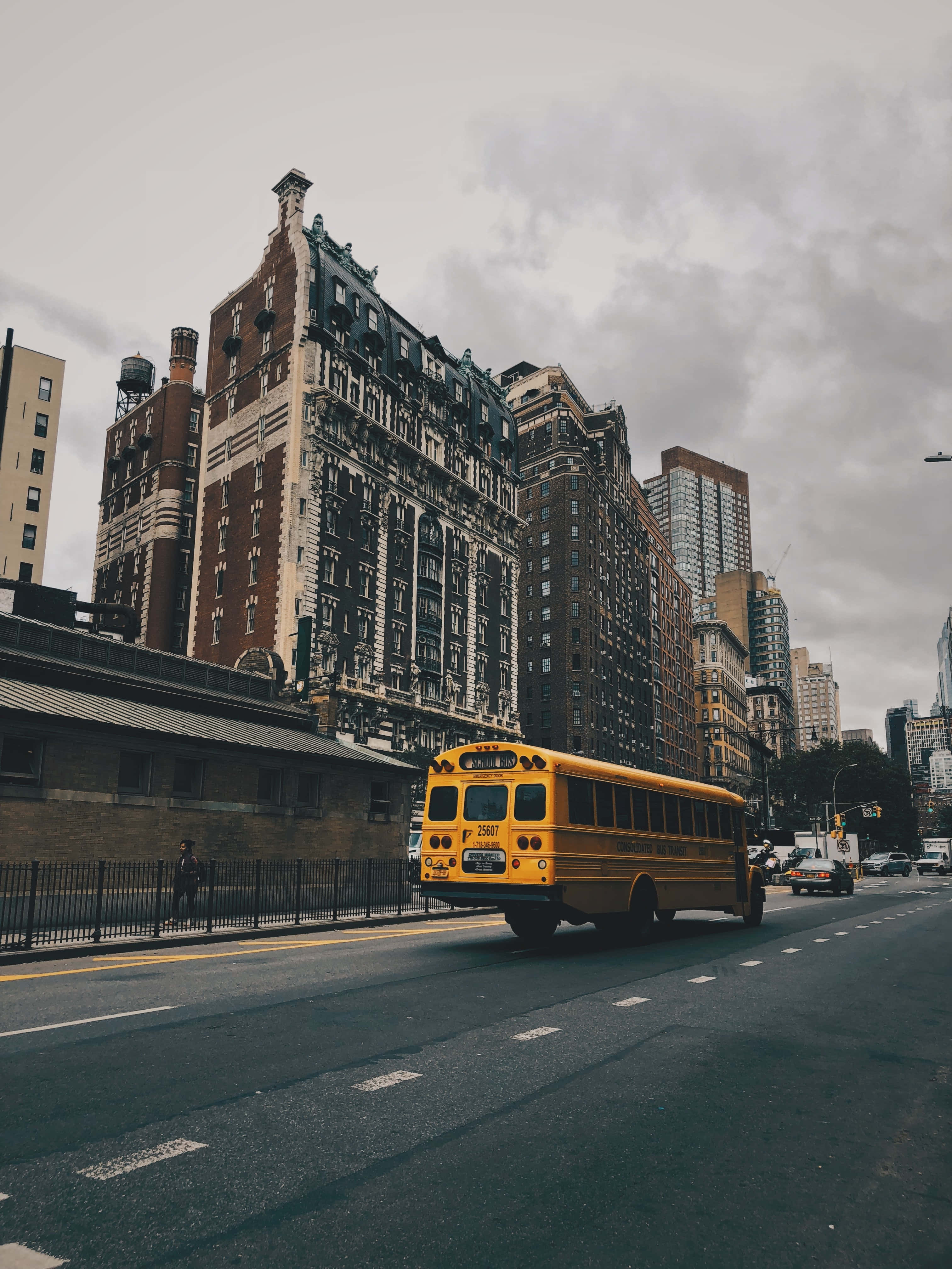 Yellow School Bus, wet city street, ornate brownstone buildings, 4K Phone Wallpaper