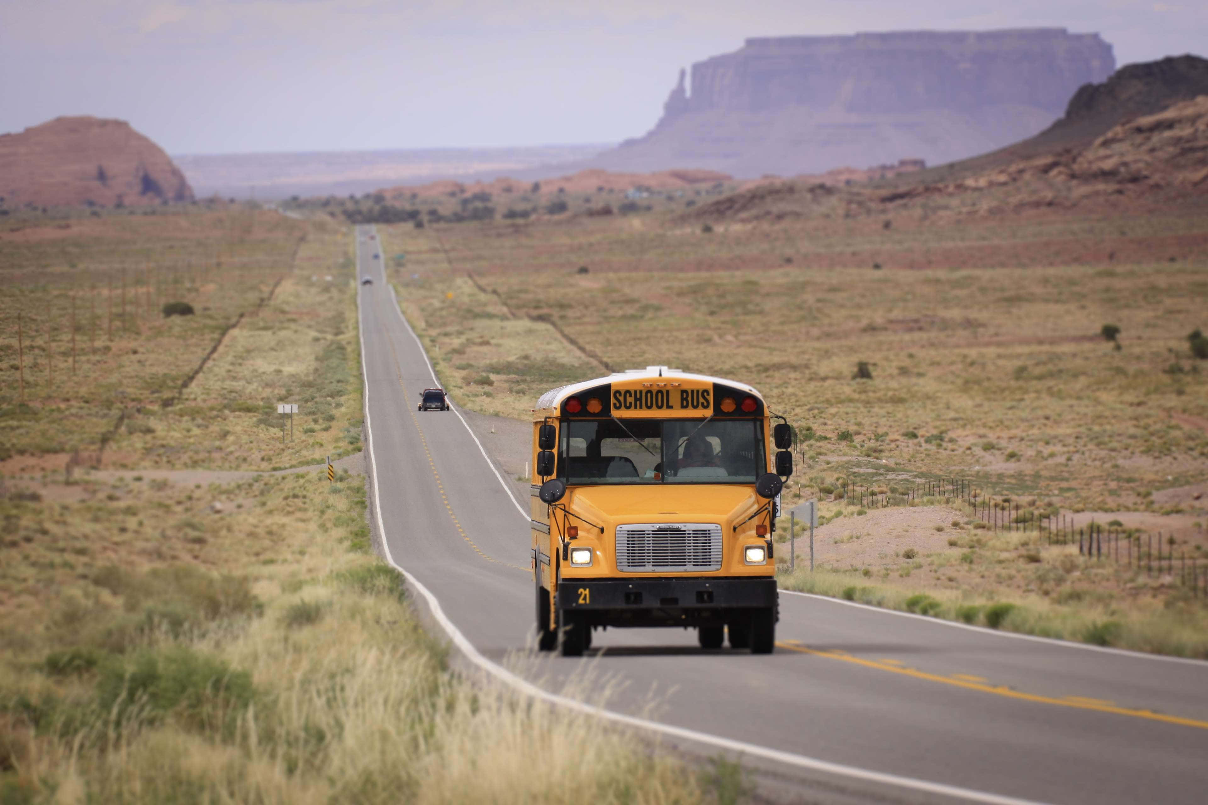 yellow school bus, long straight road, arid desert landscape, 4K Desktop Wallpaper