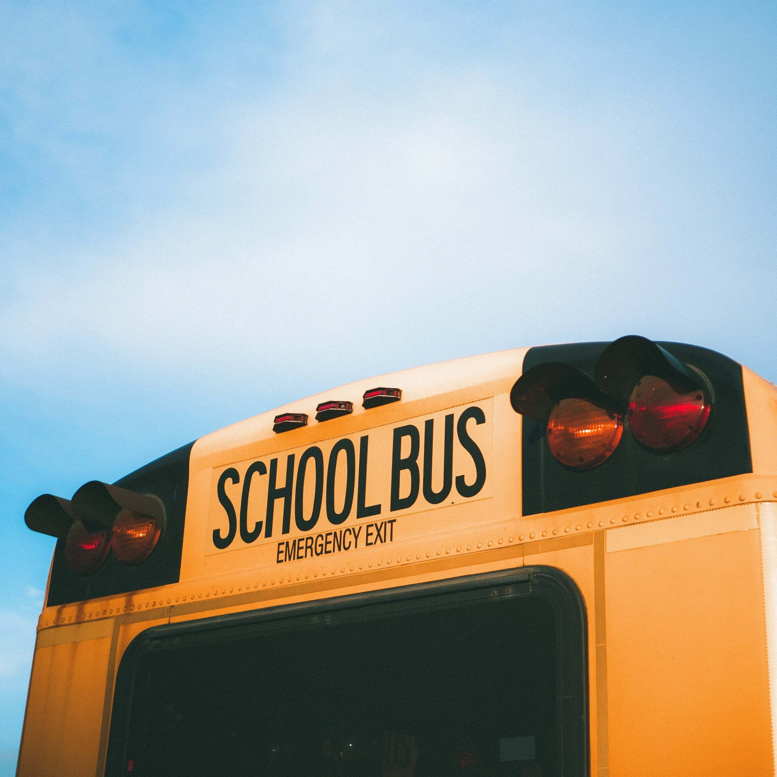 yellow school bus, red emergency lights, soft blue sky, Full HD Desktop Wallpaper