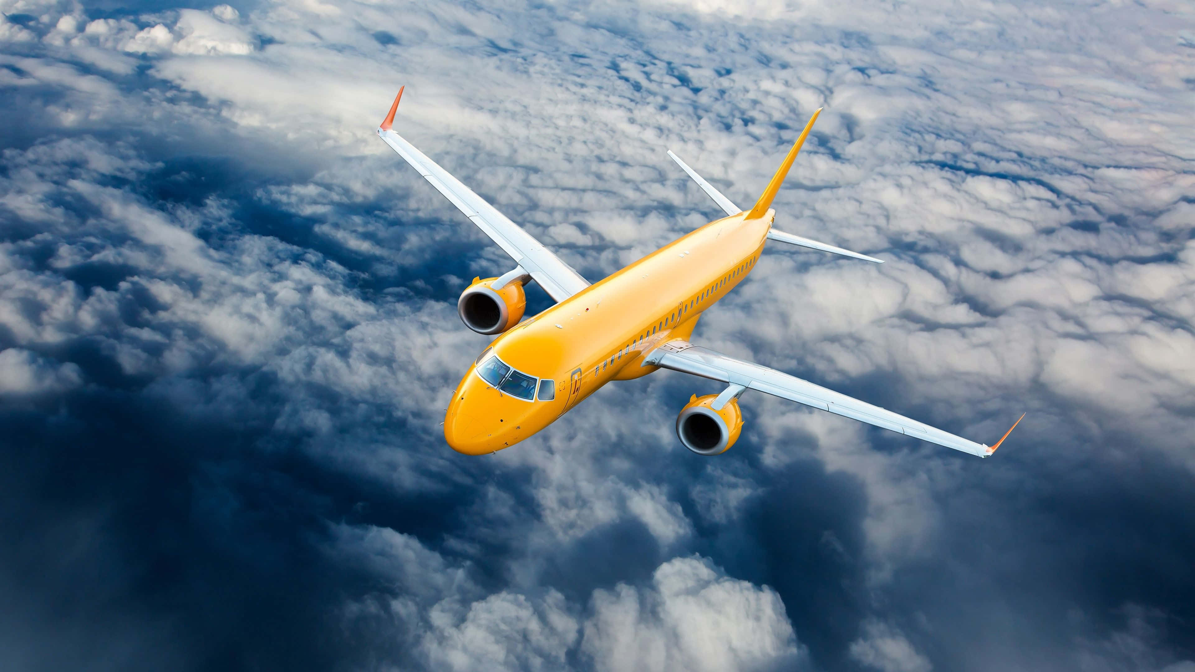 yellow airplane, bright yellow passenger jet, fluffy white clouds, 4K Desktop Wallpaper