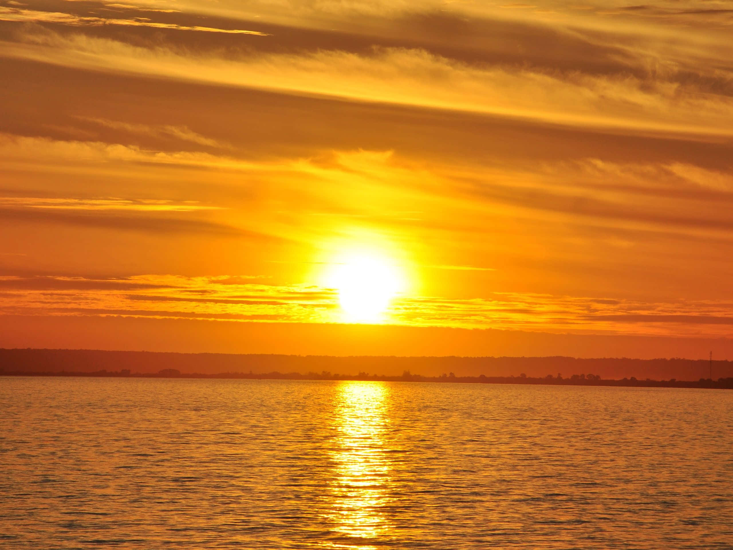 Yellow Sunset, golden light, calm body of water, 2K Desktop Wallpaper