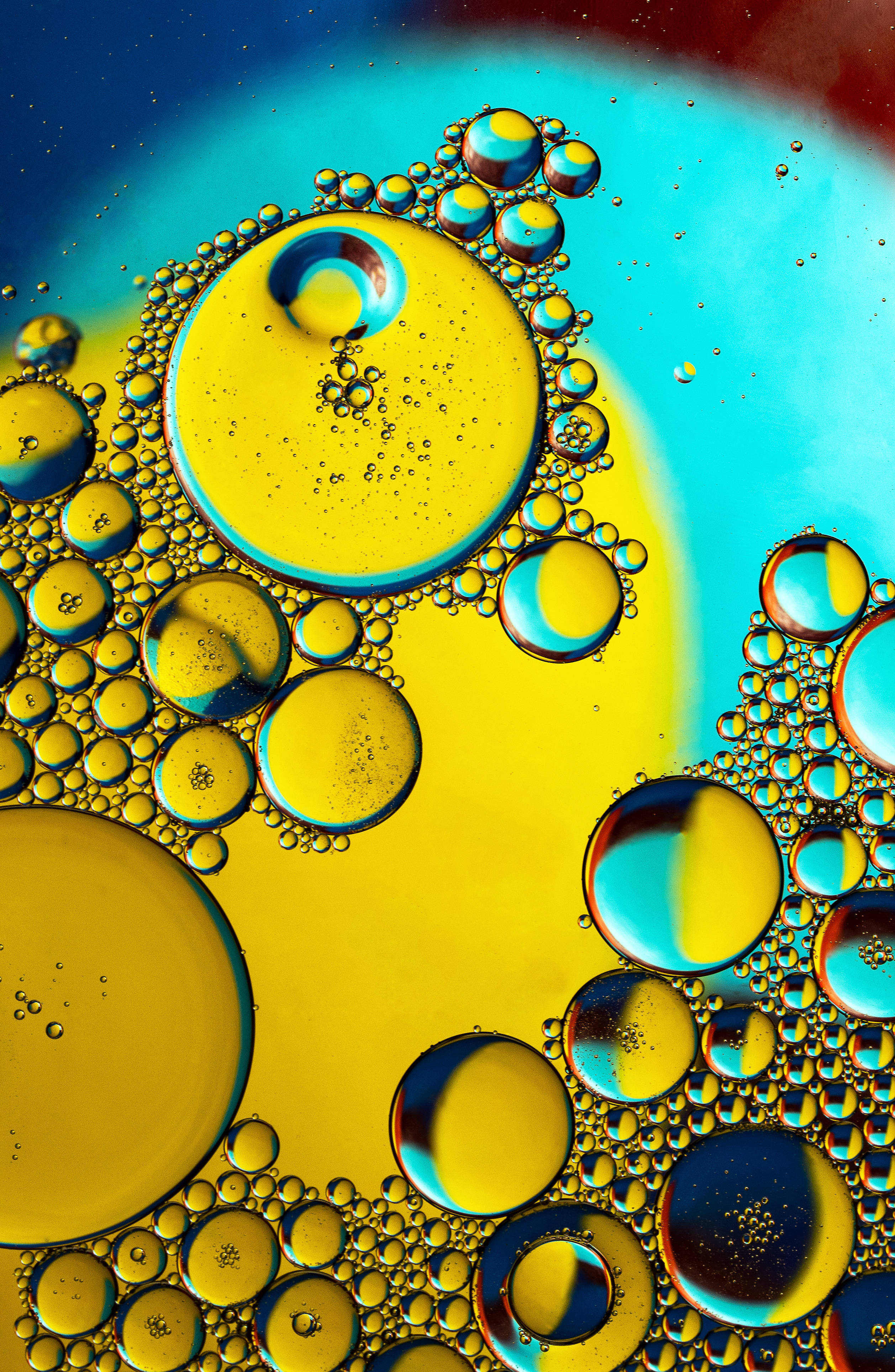 Vibrant yellow, blue oil bubbles, mesmerizing abstract pattern, 4K Phone Wallpaper