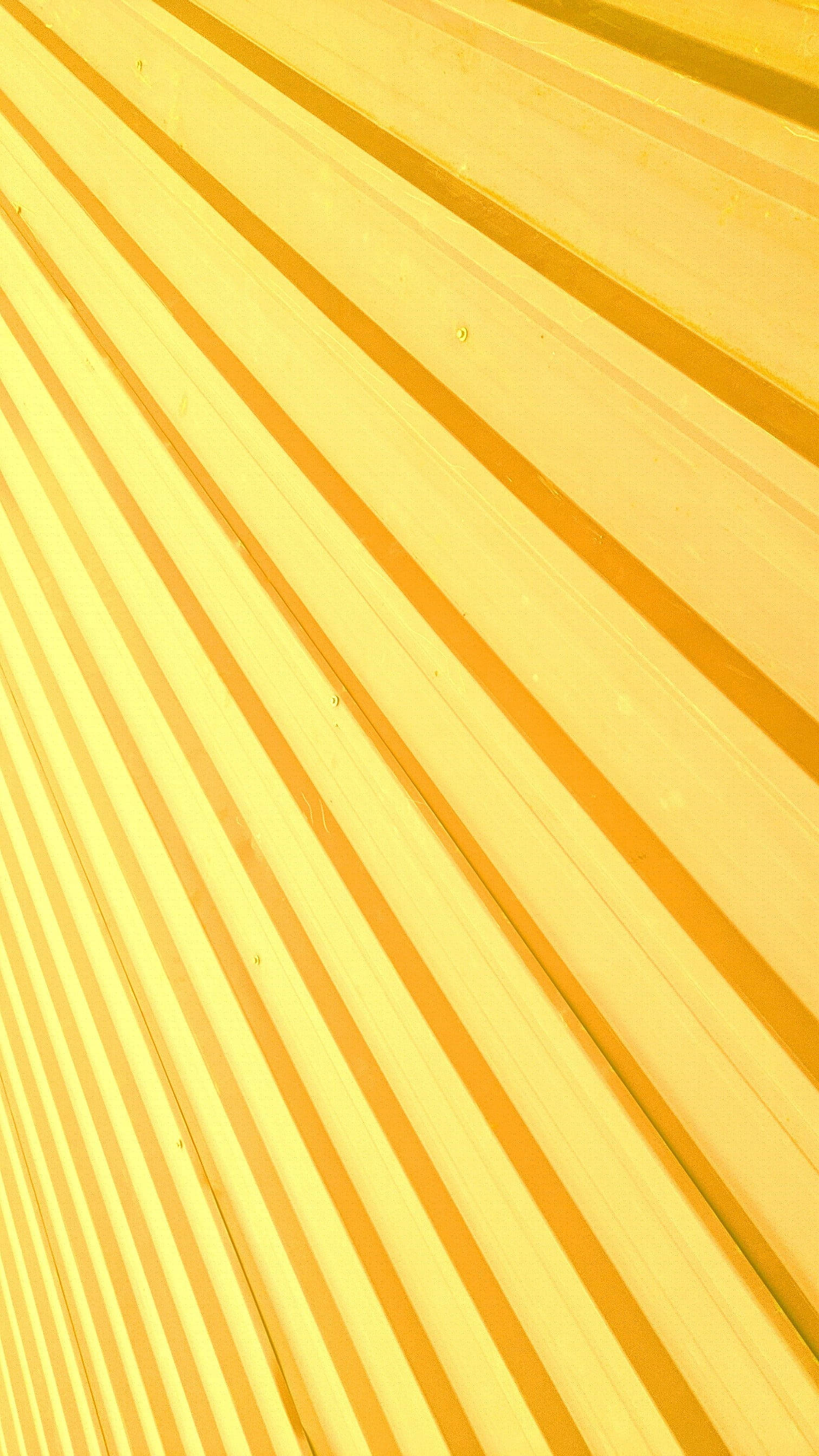 plain yellow abstract texture, diagonal yellow corrugated metal panels, warm lighting, 2K Phone Wallpaper