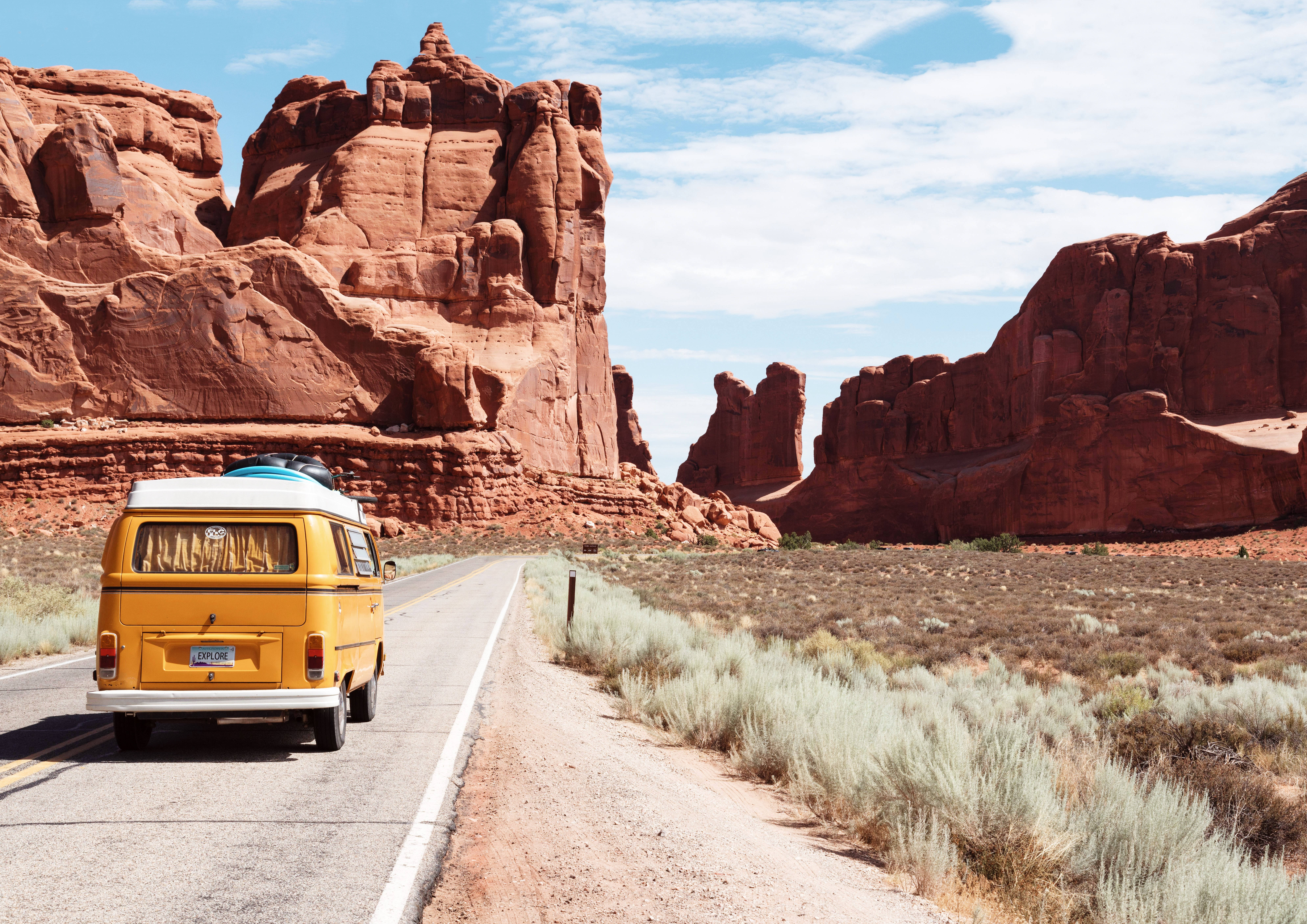 yellow vintage aesthetic van, desert road, towering red rock formations, 8K Desktop Wallpaper