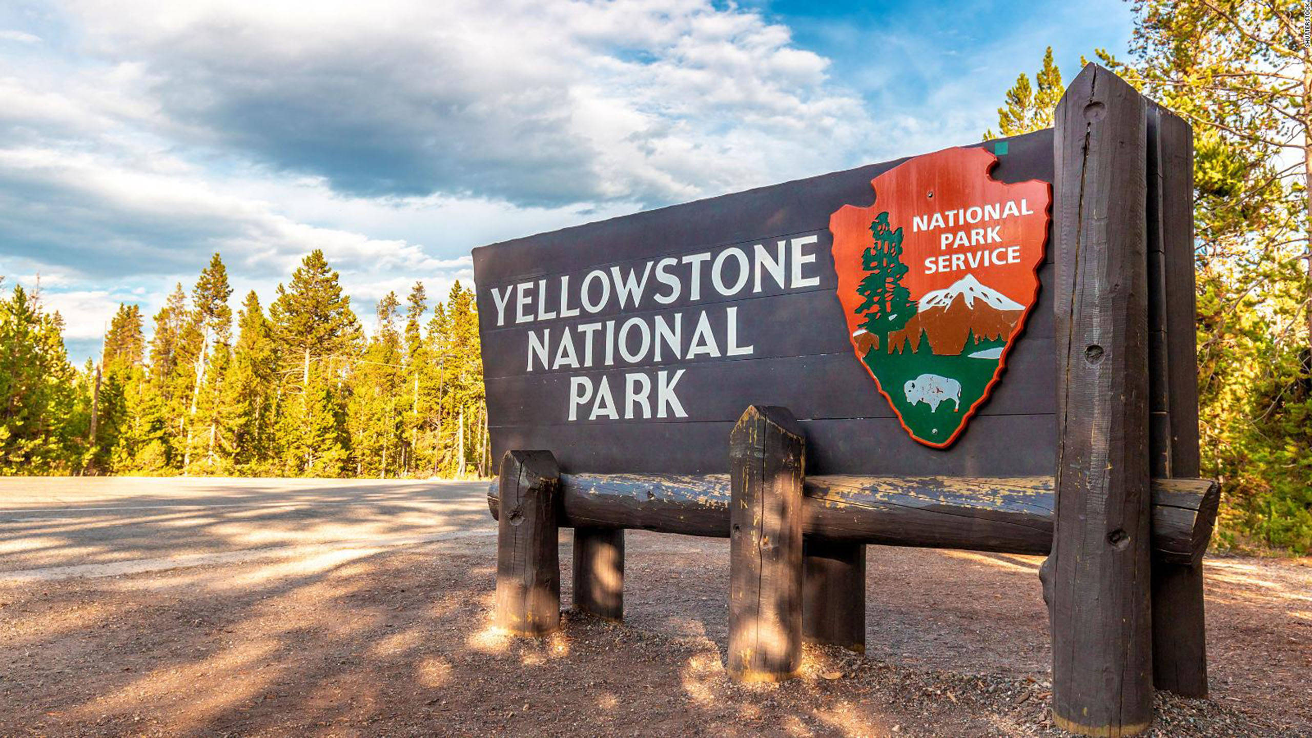 Yellowstone National Park, wooden sign, partly cloudy sky, 2K Desktop Wallpaper