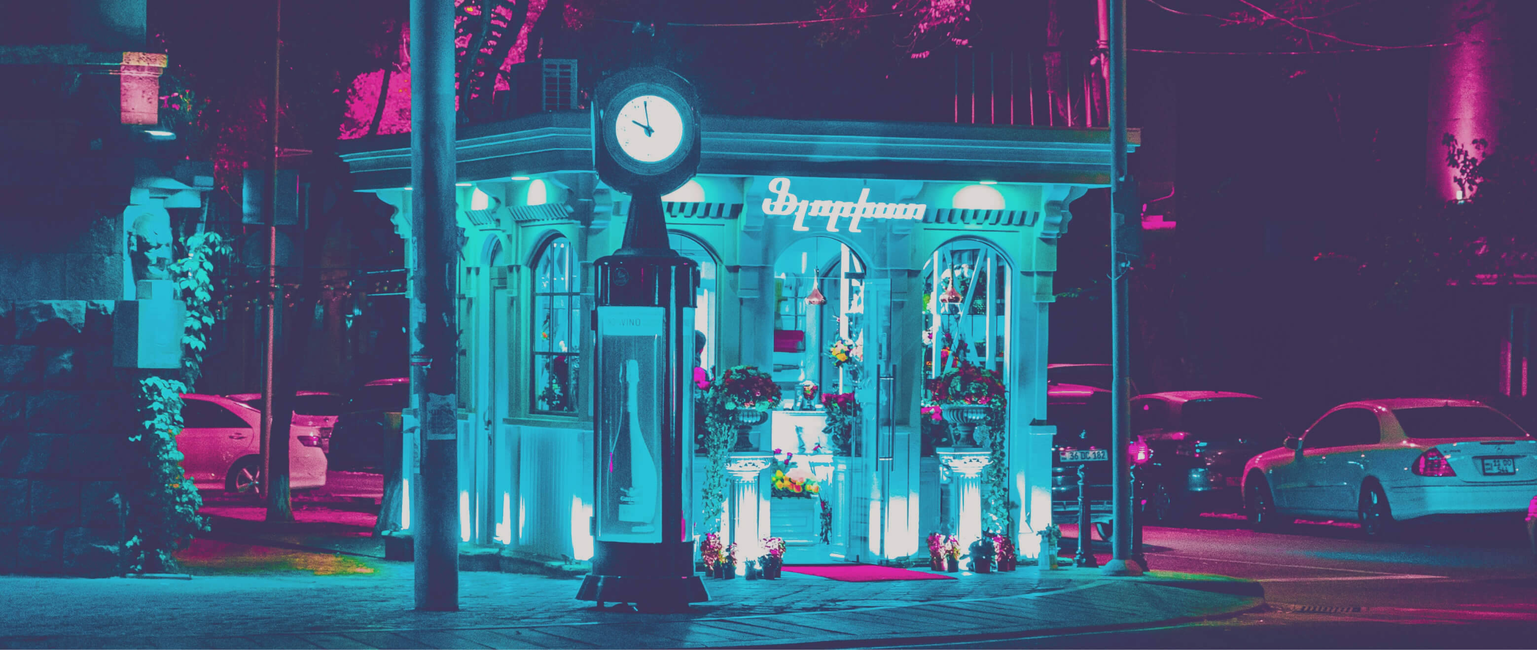 Night In Yerevan, neon-drenched vintage clock tower, glowing storefront, 2K Desktop Wallpaper