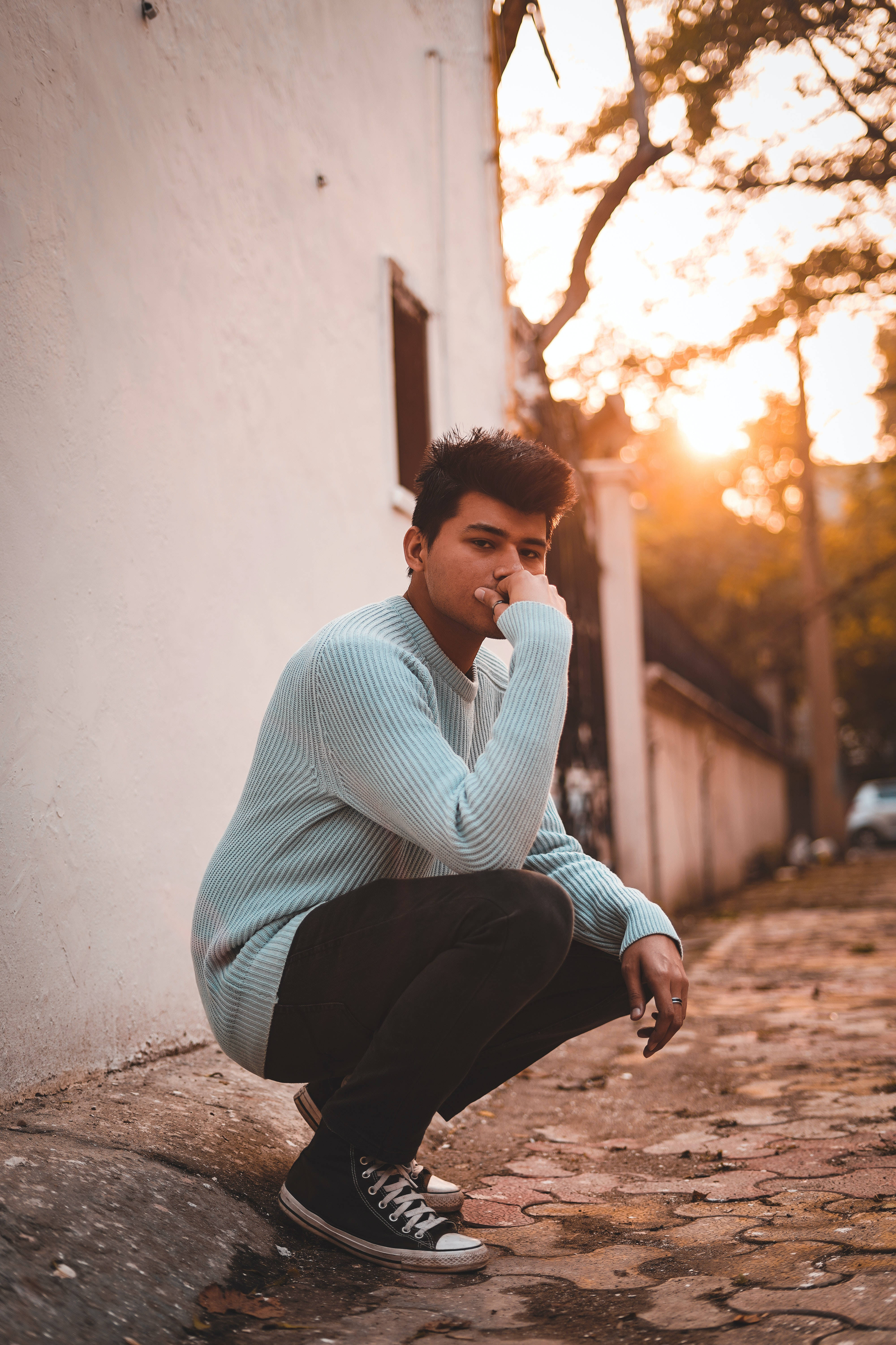 light blue sweater, white wall, golden sunset, 5K Phone Wallpaper