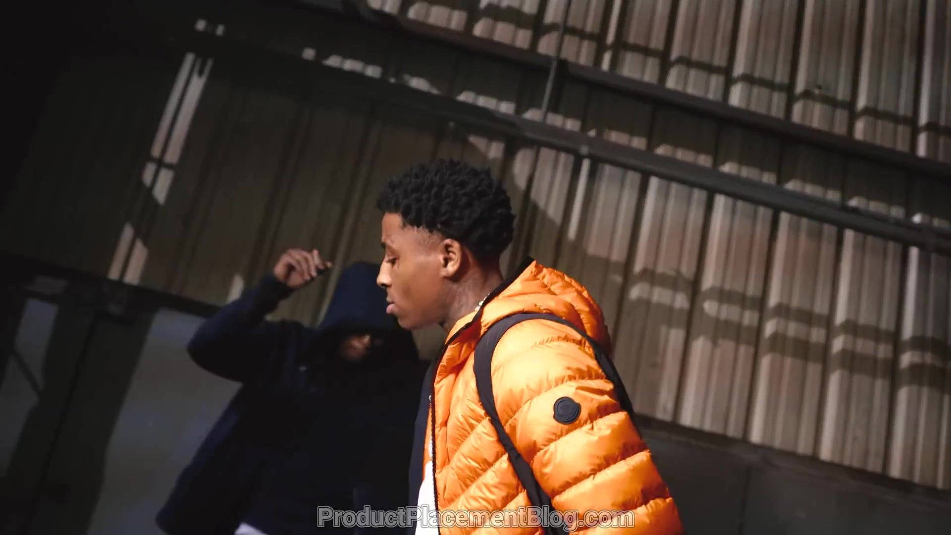 Youngboy Never Broke Again, bright orange puffer jacket, dimly lit industrial space, Full HD Desktop Wallpaper