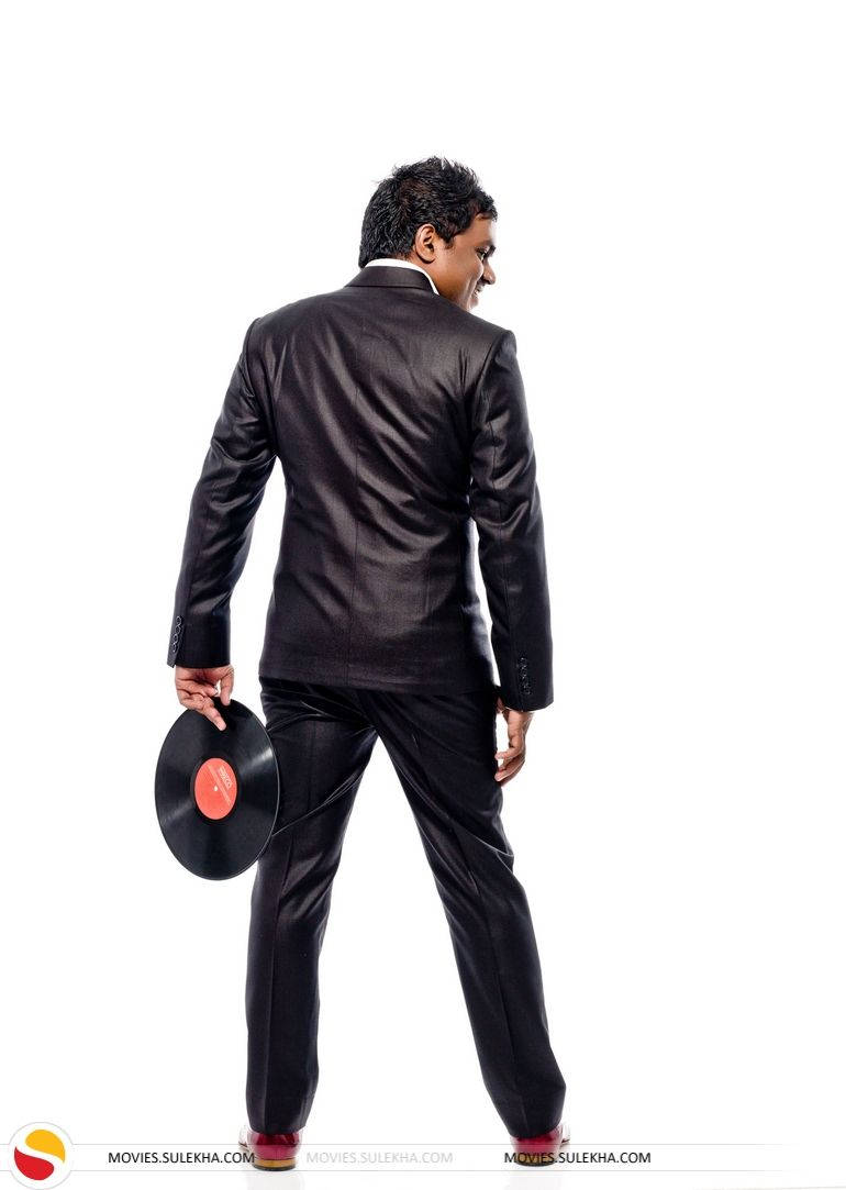 Yuvan Shankar Raja, sleek black suit, vinyl record, SD Phone Wallpaper