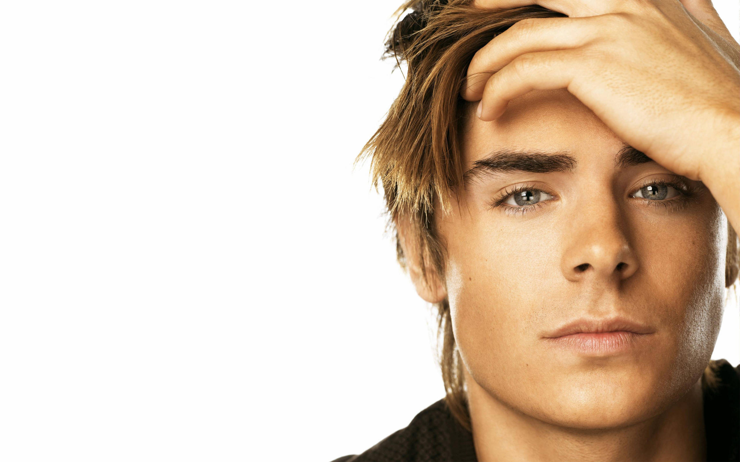 Zac Efron, tousled brown hair, intense gaze, 2K Desktop Wallpaper