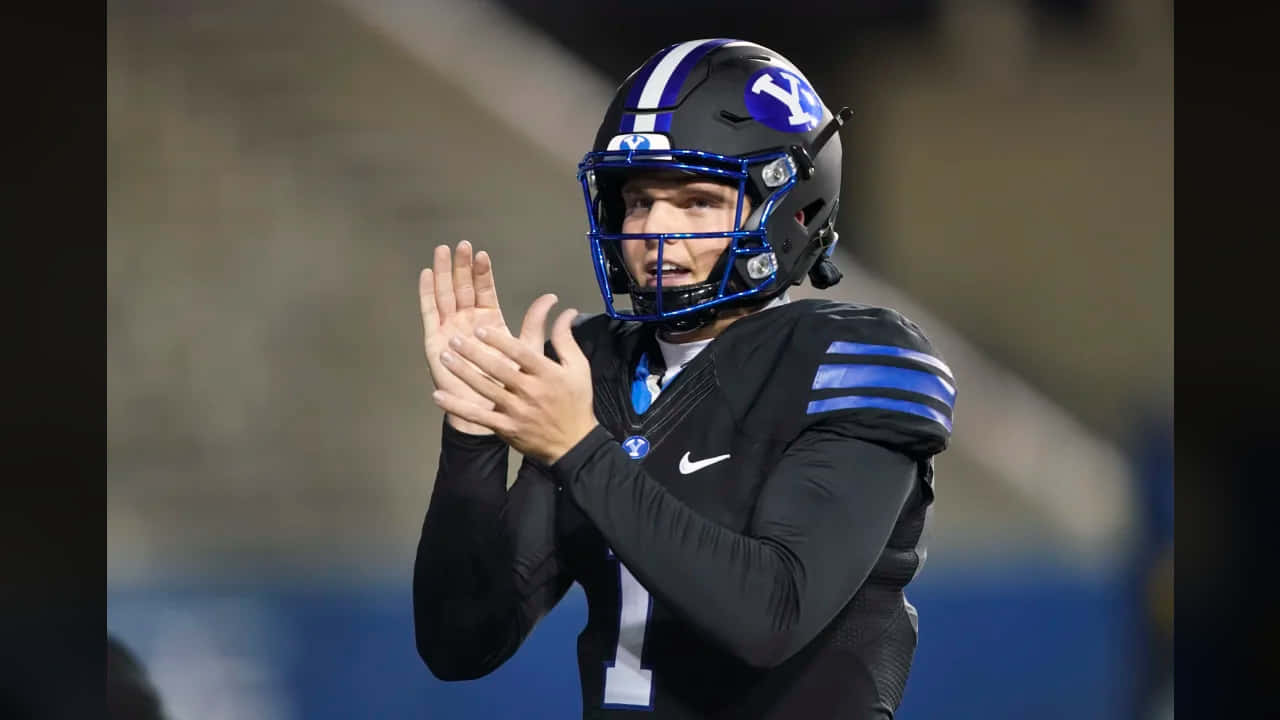 Zach Wilson, black and blue uniform, helmet with a faceguard, HD Desktop Wallpaper